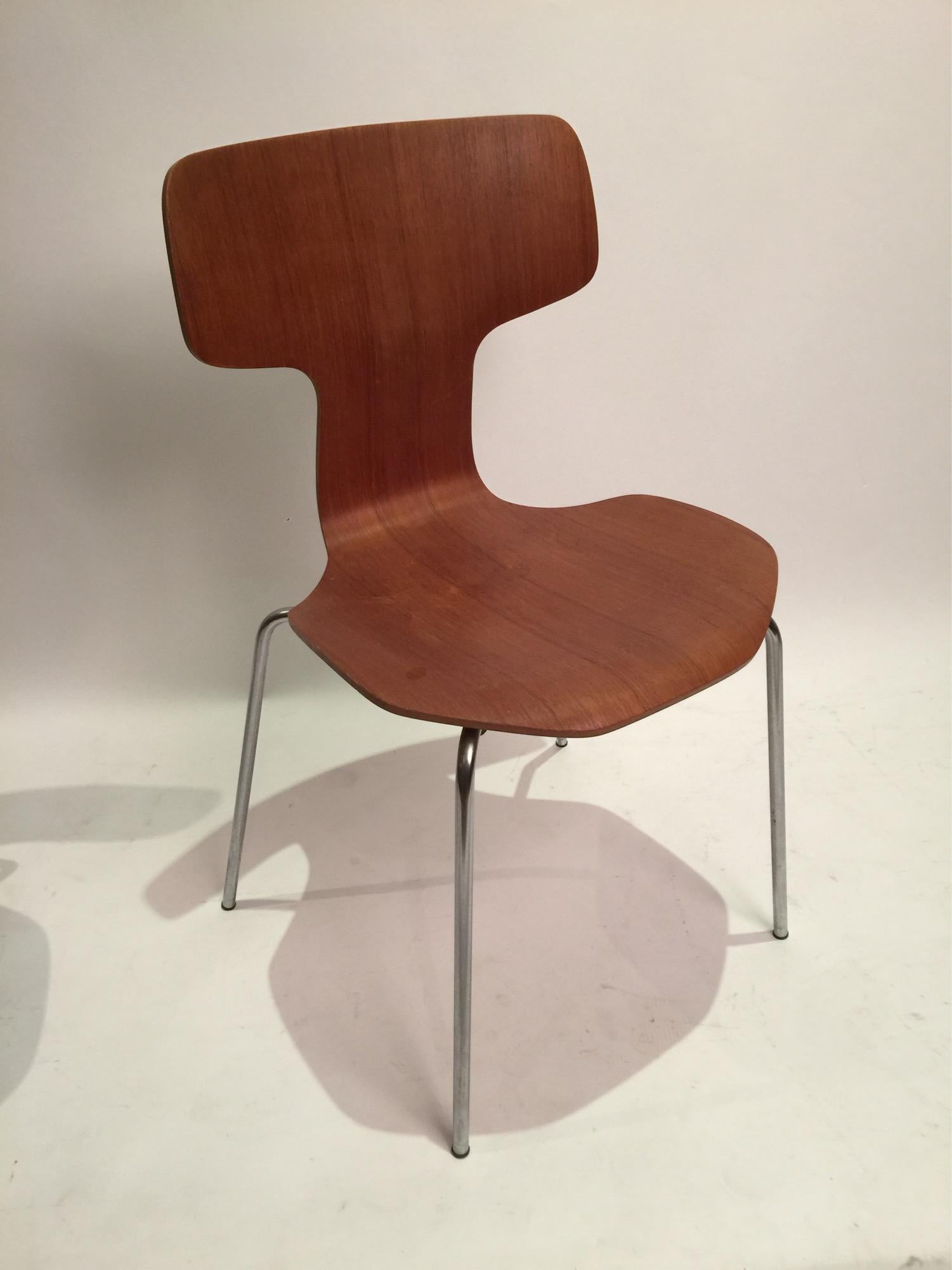 Teak plywood chairs designed by Arne Jacobsen and executed by Fritz Hansen Denmark. The 3103 chair, no longer in production, shares a design platform with the more common Series 7 as well as the Grand Prix chairs.
    