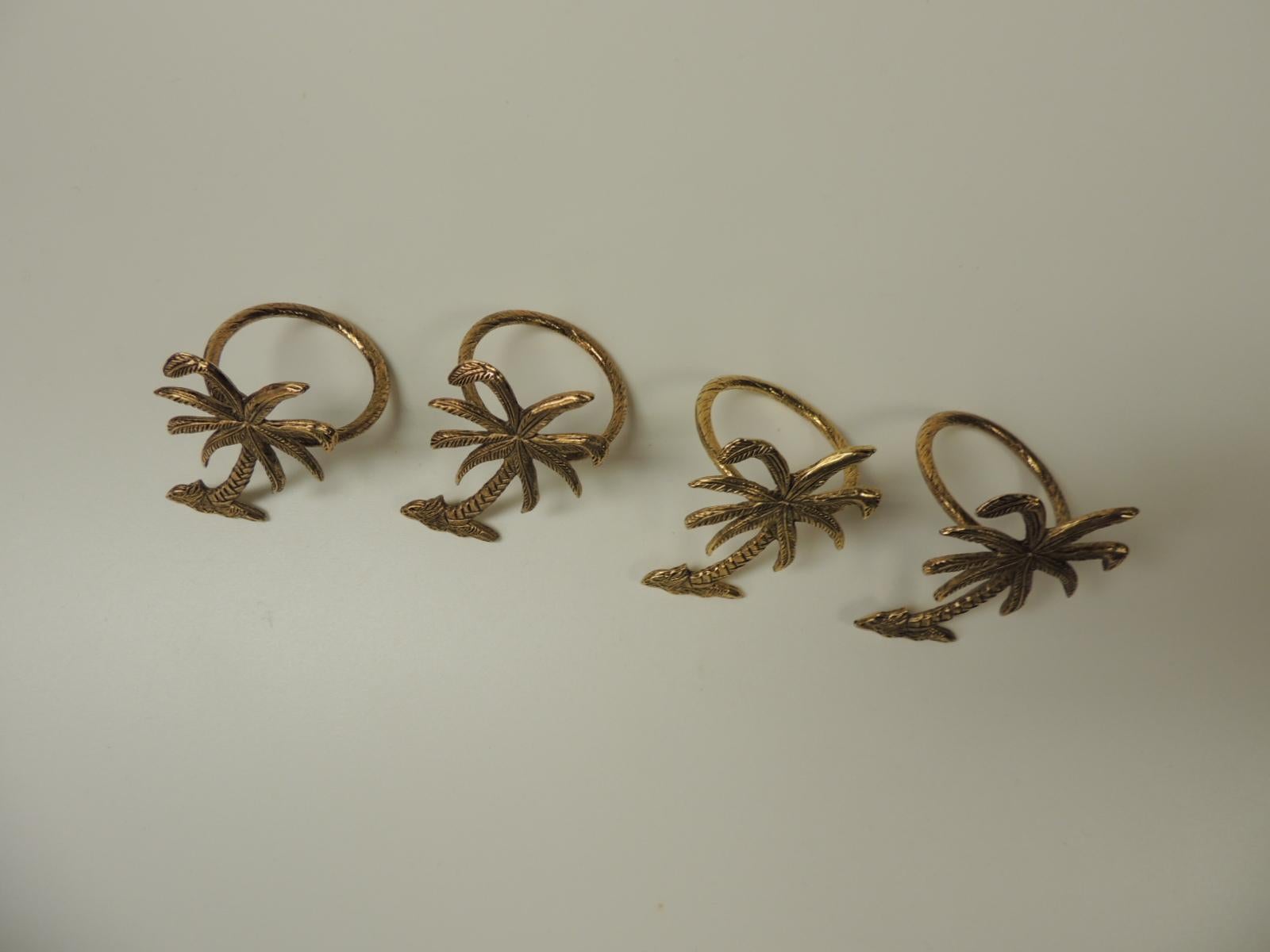 Set of four (4) decorative palm trees napkin holders
Gold tone round dinner napkin holders.
China
1990s
Size: 1 ¾ D x 2.5H.
 