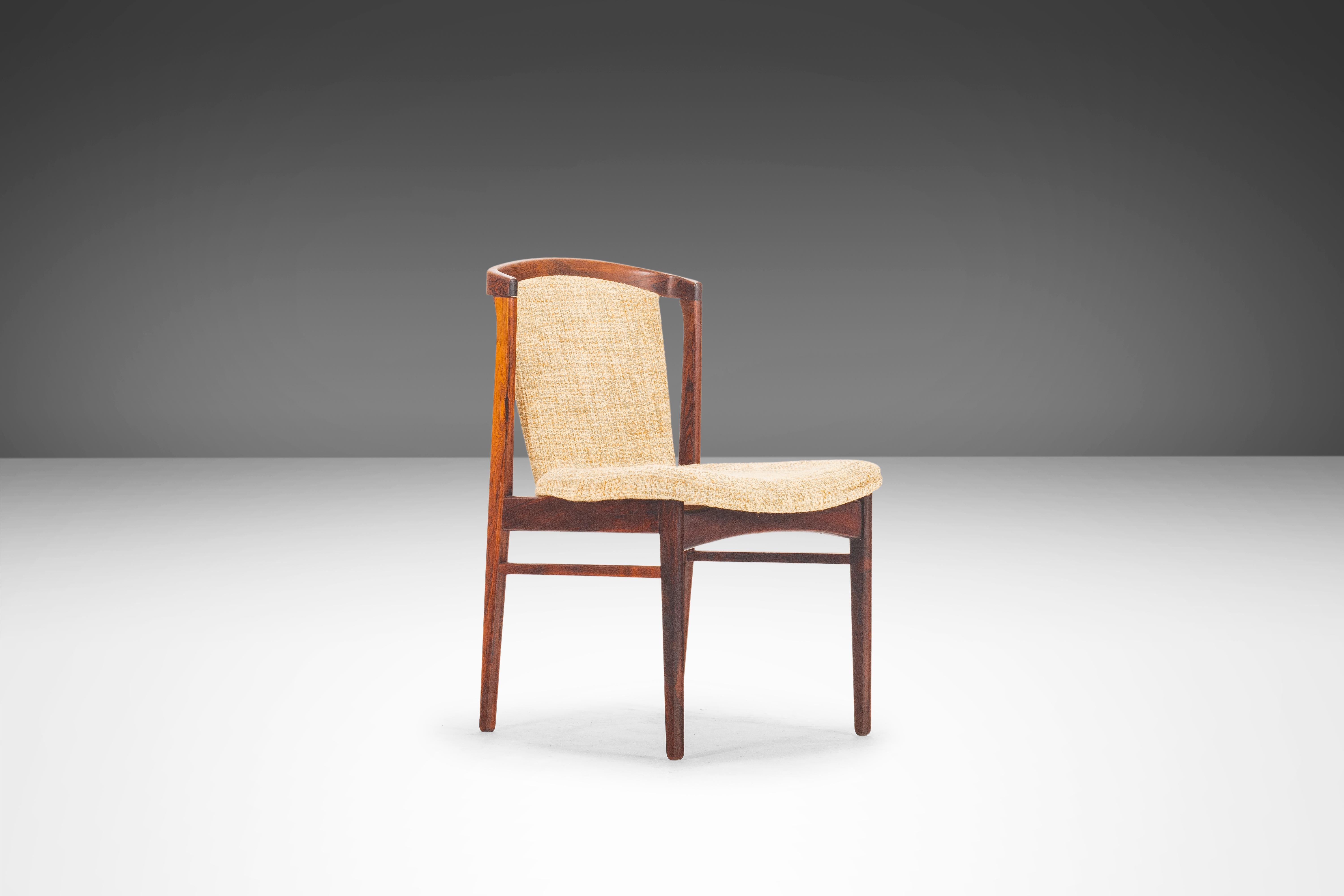 As rare as they are aesthetically breathtaking this set of four dining chairs by Erik Buch for Orum Mobler is in 100% original, vintage condition. Extremely comfortable with a unique curved back and solid rosewood construction, the chairs were