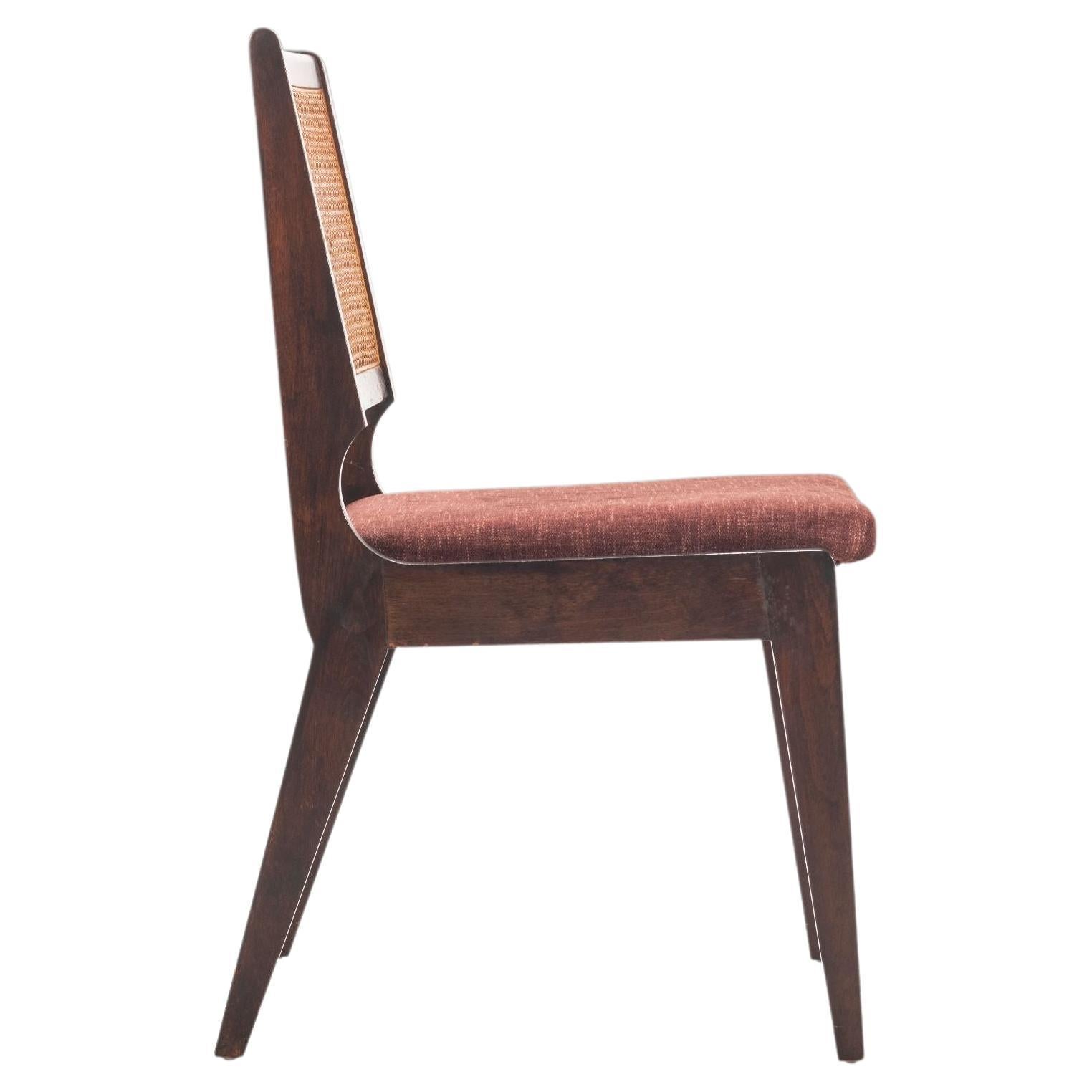 For your consideration is a sophisticated set of dining chairs in the manner of Edward Wormley. The original cane has aged to perfection with beautiful warm amber color. The ebonized frames have a patina adding to the worldly character of the set