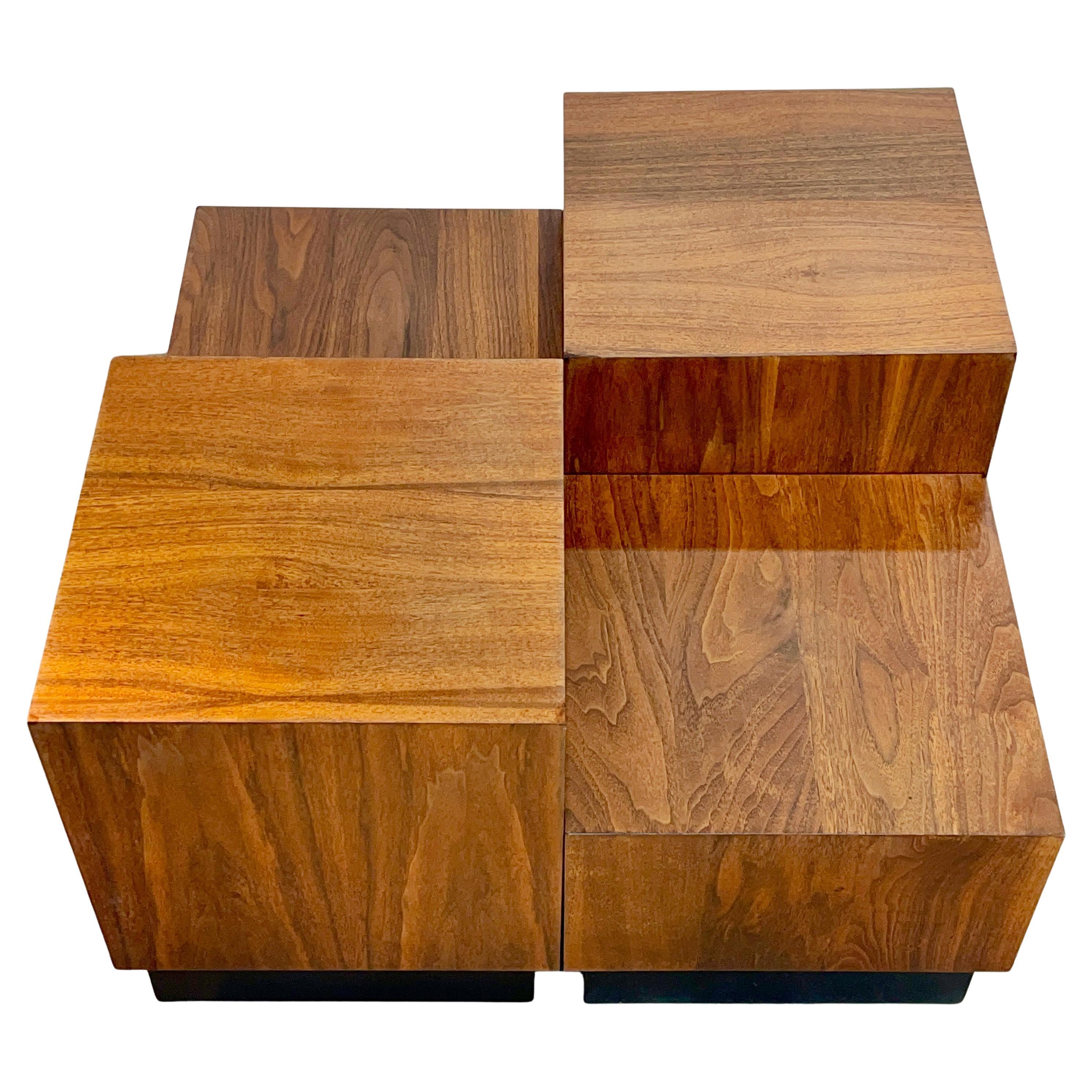 Set of four walnut veneered cube tables on black recessed plinth bases designed by Adrian Pearsall and produced by Craft Associates in 1969.
Can be used clustered together as a cocktail table, side tables, end tables or as pedestals for displaying