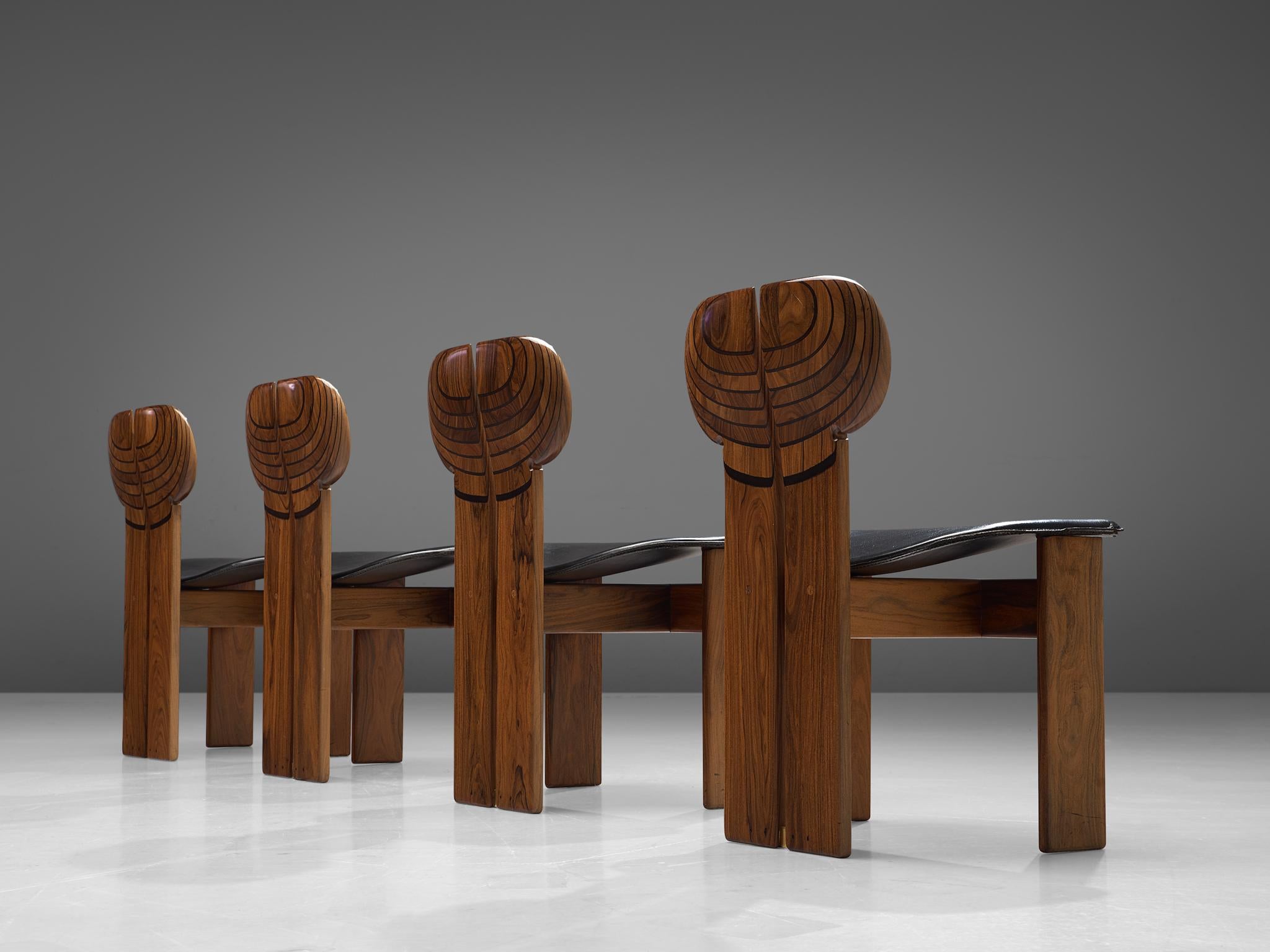 Afra & Tobia Scarpa, set of four dining chairs, black leather, walnut, ebony and brass, Maxalto, Italy, 1975.

This set of 'Africa' chairs explicitly sculptural grand chairs are designed by Afra & Tobia Scarpa and are part of the Artona collection