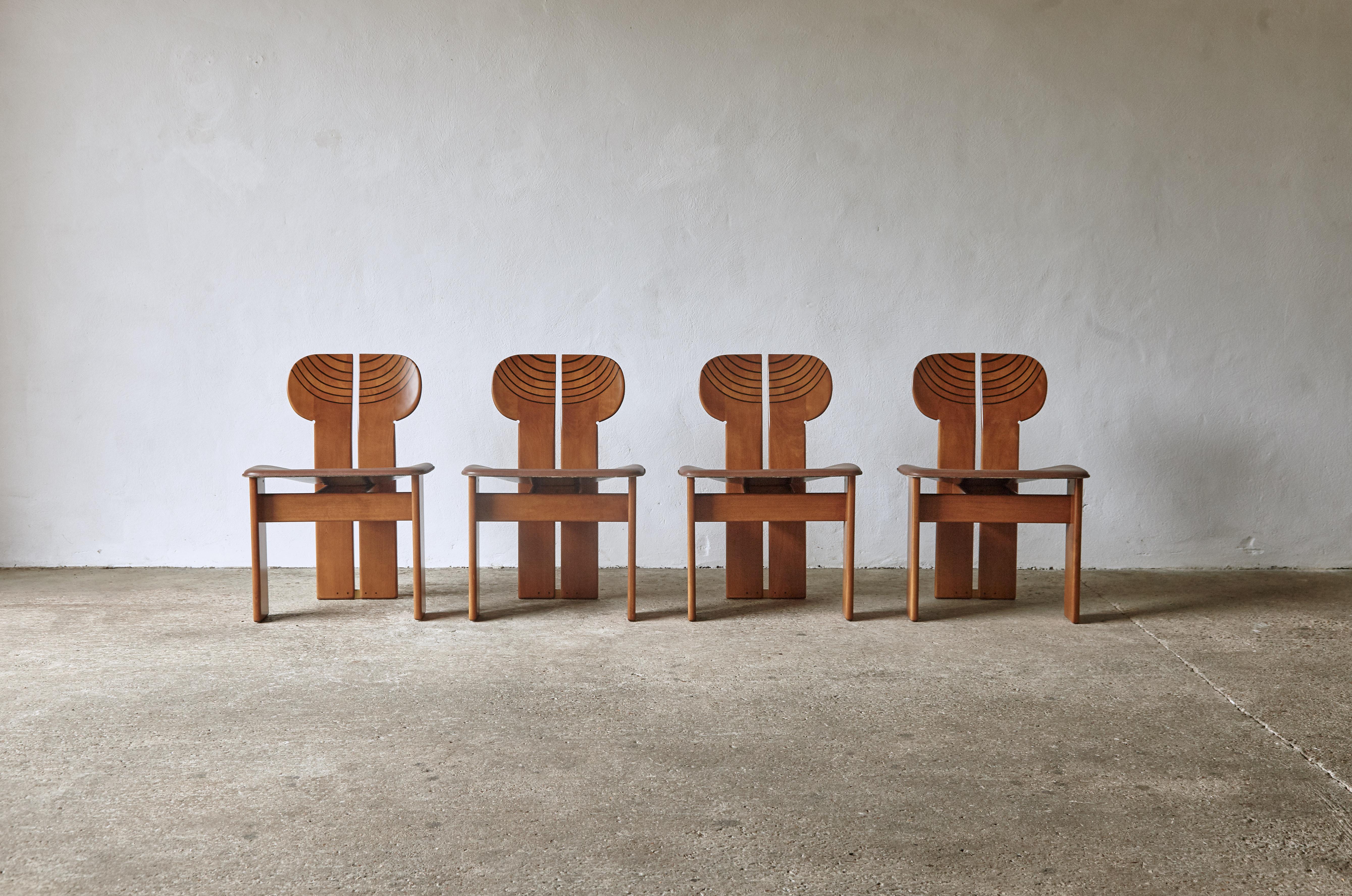 A superb set of four Africa chairs designed by Afra & Tobia Scarpa in the 1970s, and produced by Maxalto, Italy. Walnut, burl, black leather and brass. Good original condition with minor age related signs of use and wear. The original leather seats