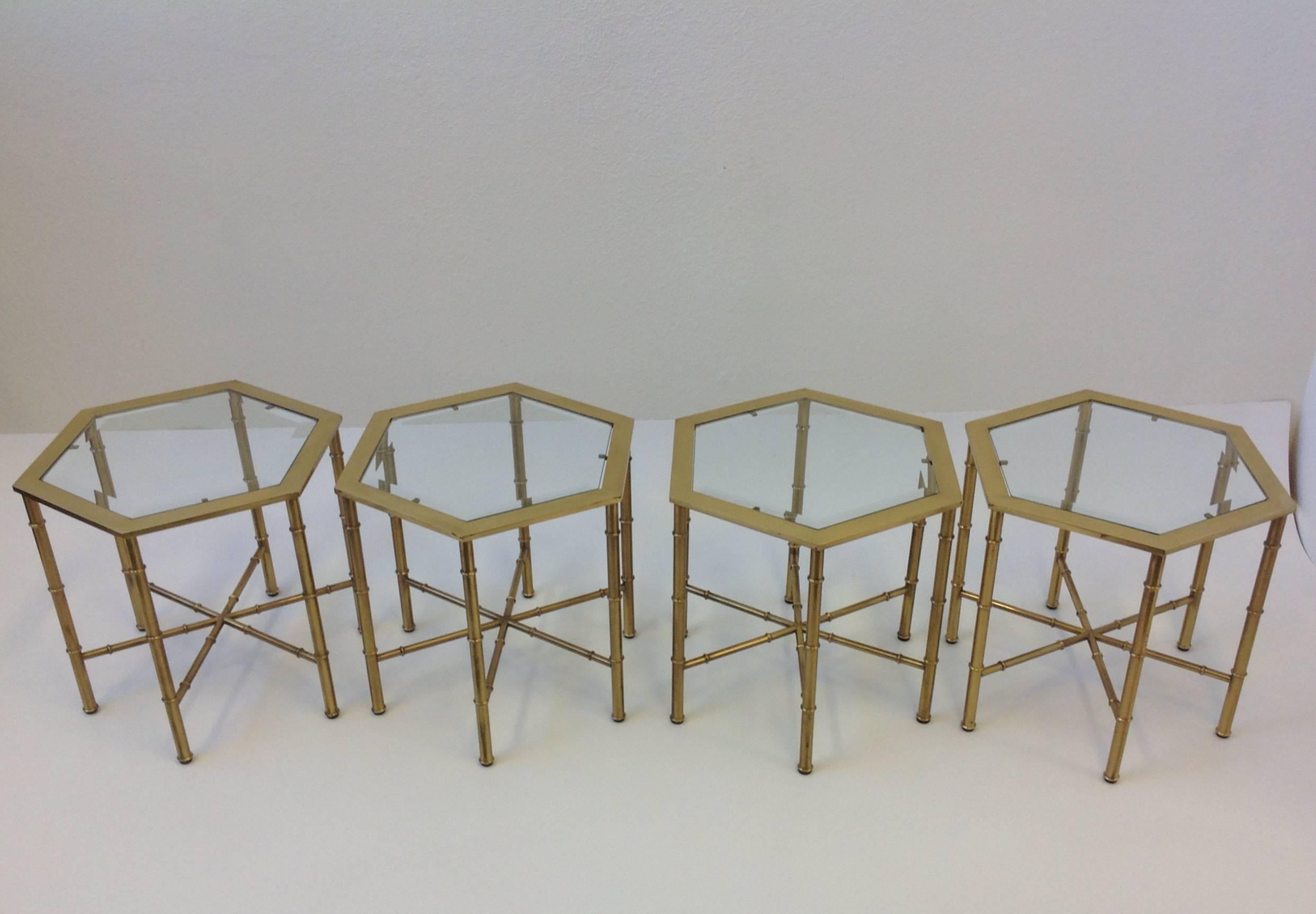 A beautiful set of four 1970s aged brass and bevelled glass inserts hexagonal shape occasional tables by Mastercraft. This can be used as a coffee table together or as side tables.
The frames are in original condition, so they show some age on the