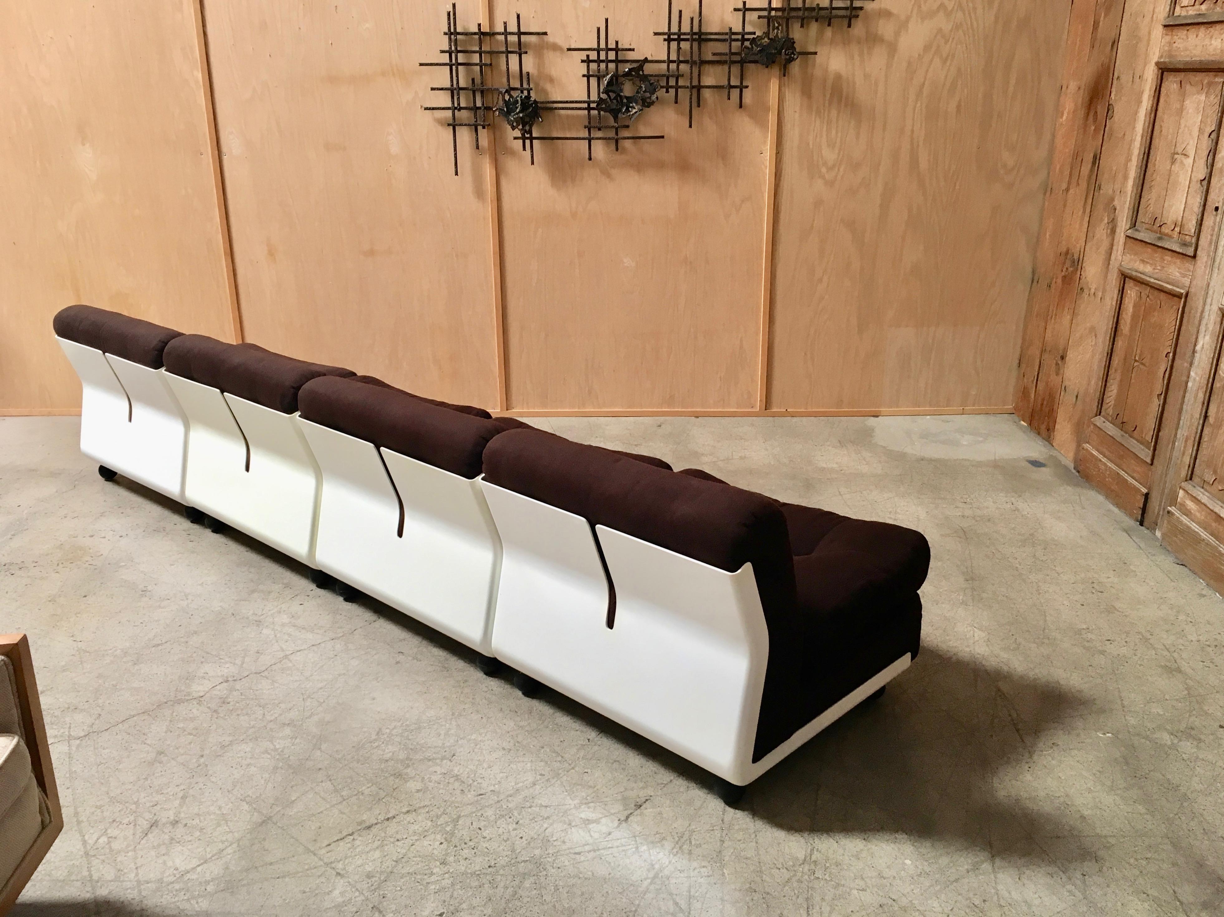 The shells are white fiberglass with chocolate brown fabric cushions that are very comfortable these can be used as lounge chairs, love seats or a large sofa great Italian design.