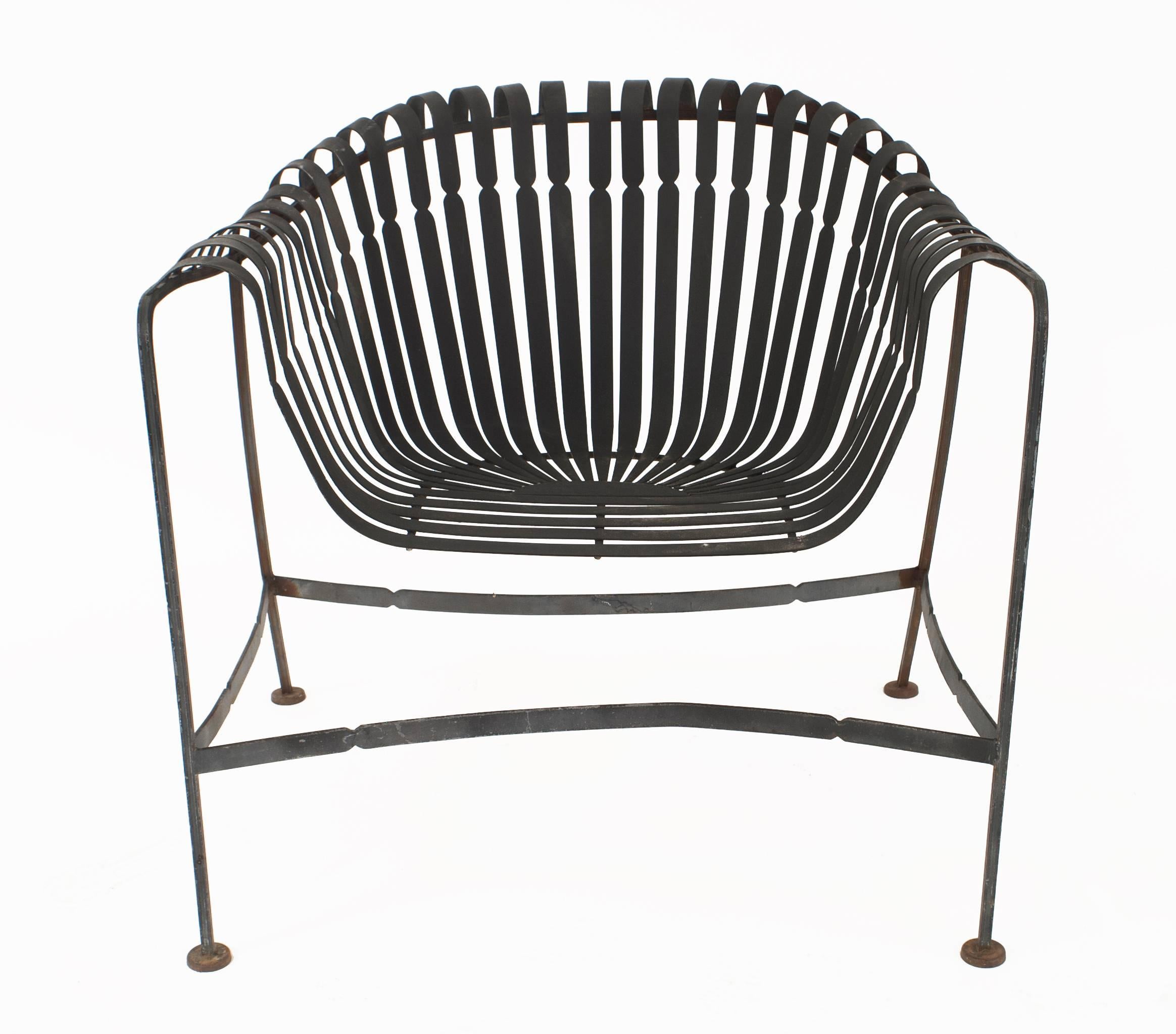 Set of Four American midcentury 1960's black enameled iron outdoor arm chairs with a scoop seat bent slat design, by Russell Woodard.


For over 150 years, Woodard craftsmen have designed and manufactured products loyal to the timeless art of