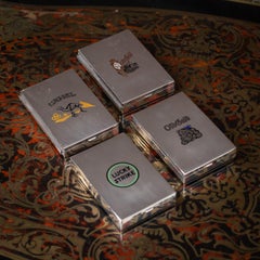 Ensemble de quatre boîtes à cigarettes américaines en argent massif et émail par Cartier