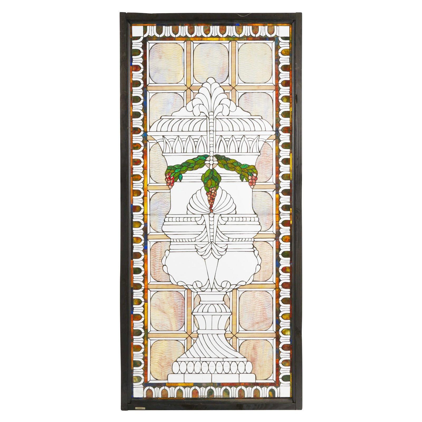 Set of four American Victorian leaded glass windows, Late 19th century
 
A set of multi-colored windows with slag glass, rippled glass, opalescent glass, and clear bevel glass with central urn and grapevine motifs, each with a different color