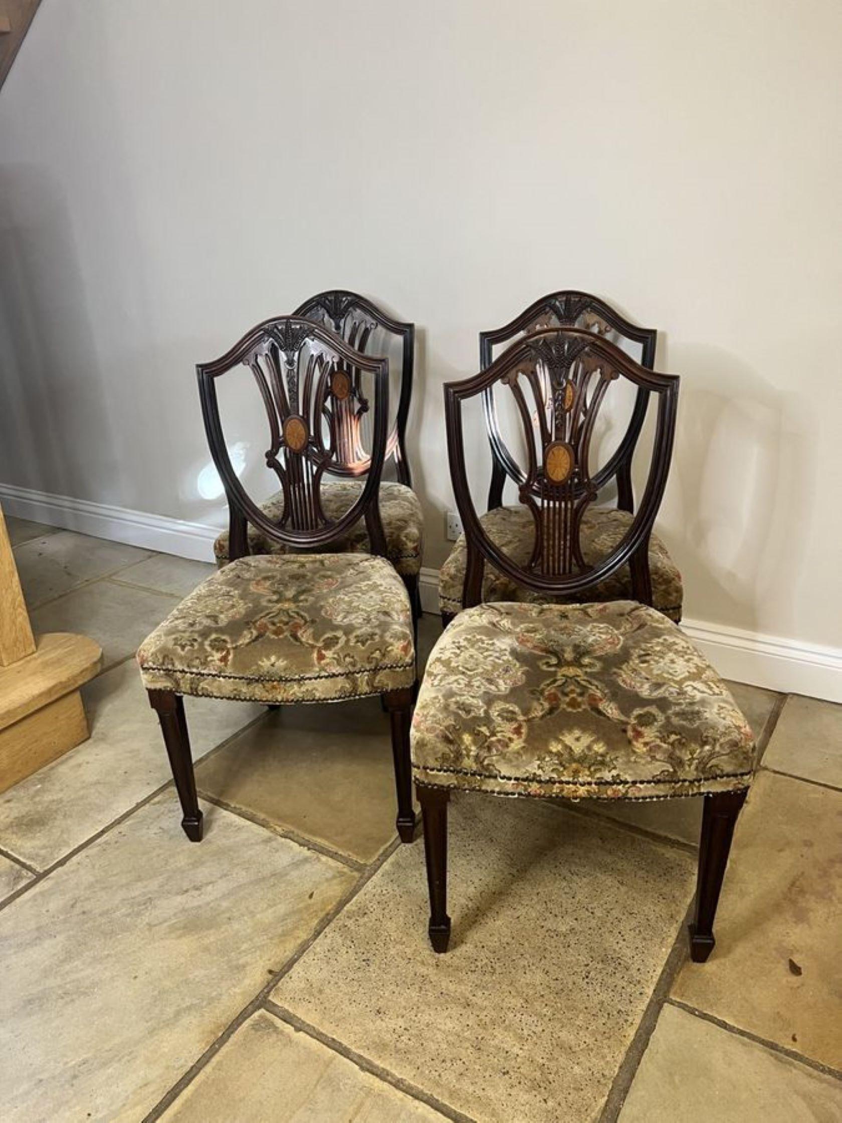 Set of four Antique Edwardian quality inlaid mahogany dining chairs having a quality carved mahogany shield shaped backs with satinwood inlaid shells to the centre, upholstered seats, standing on square tapering legs to the front with spade feet out