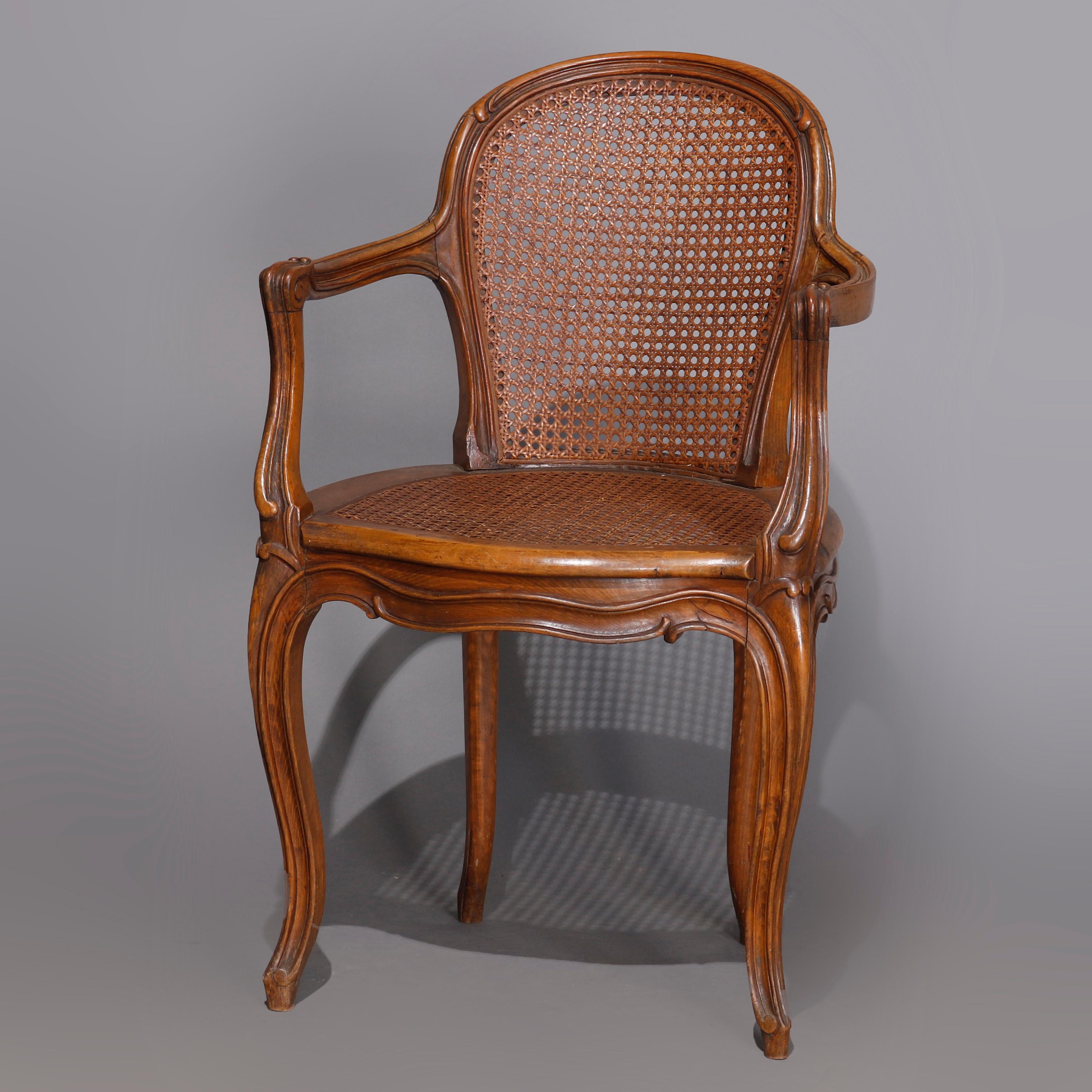 A set of four antique French Louis XVI armchairs offer carved walnut scroll form frames with curved backs raised on cabriole legs, having caned seats and backs, 19th century

***DELIVERY NOTICE – Due to COVID-19 we are employing NO-CONTACT PRACTICES