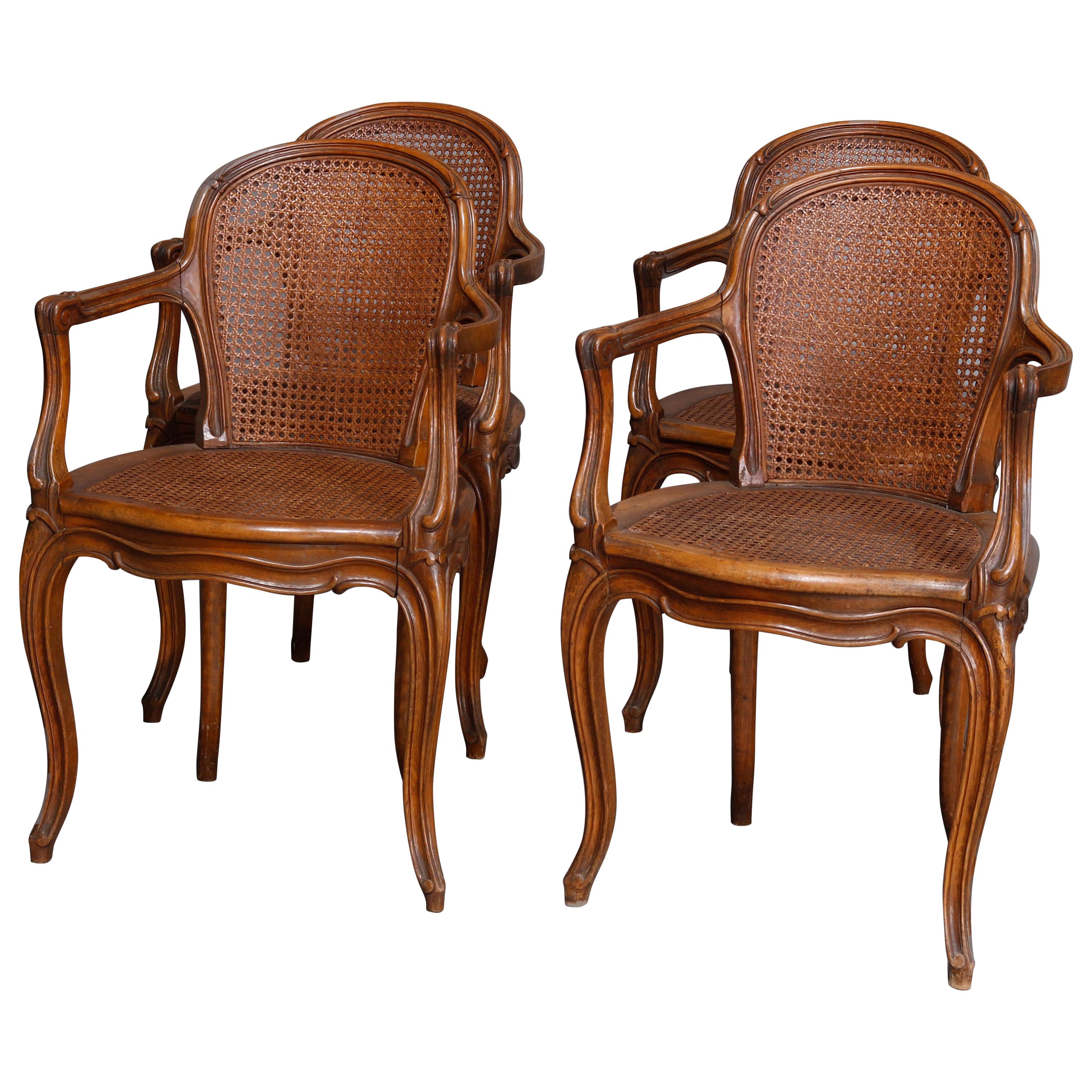 Set of Four Antique French Louis XVI Carved Walnut and Caned Armchairs