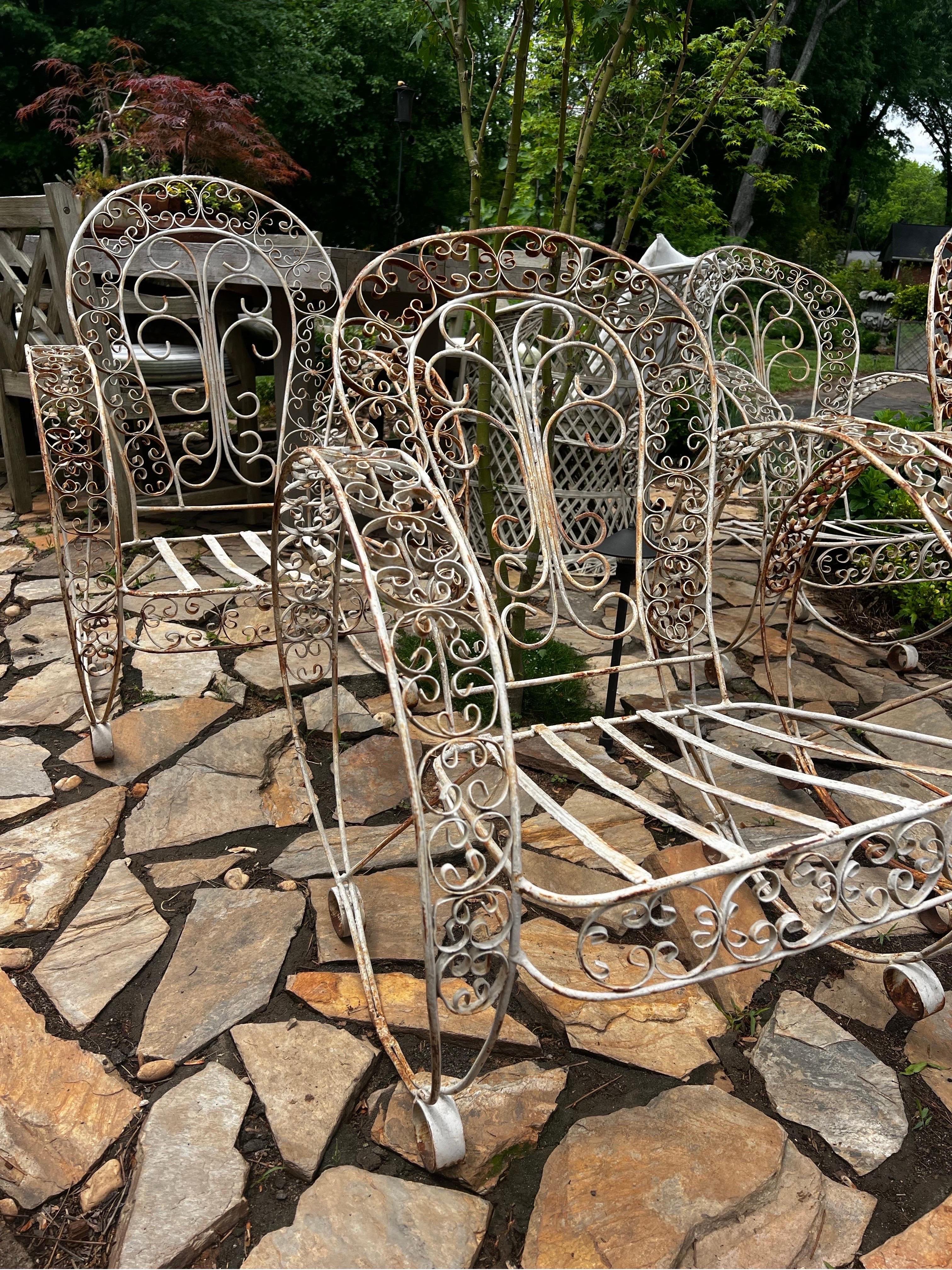 Rare Set of 4 Antique Iron French armchairs in the style of Jean-Charles Moreux.
Indoor/Outdoor patio set.  
Each chair measures approx 24 w x 27 D x 33 h x 14.5 seat height

We will be auctioning these chairs as our ironworker is backed up and they