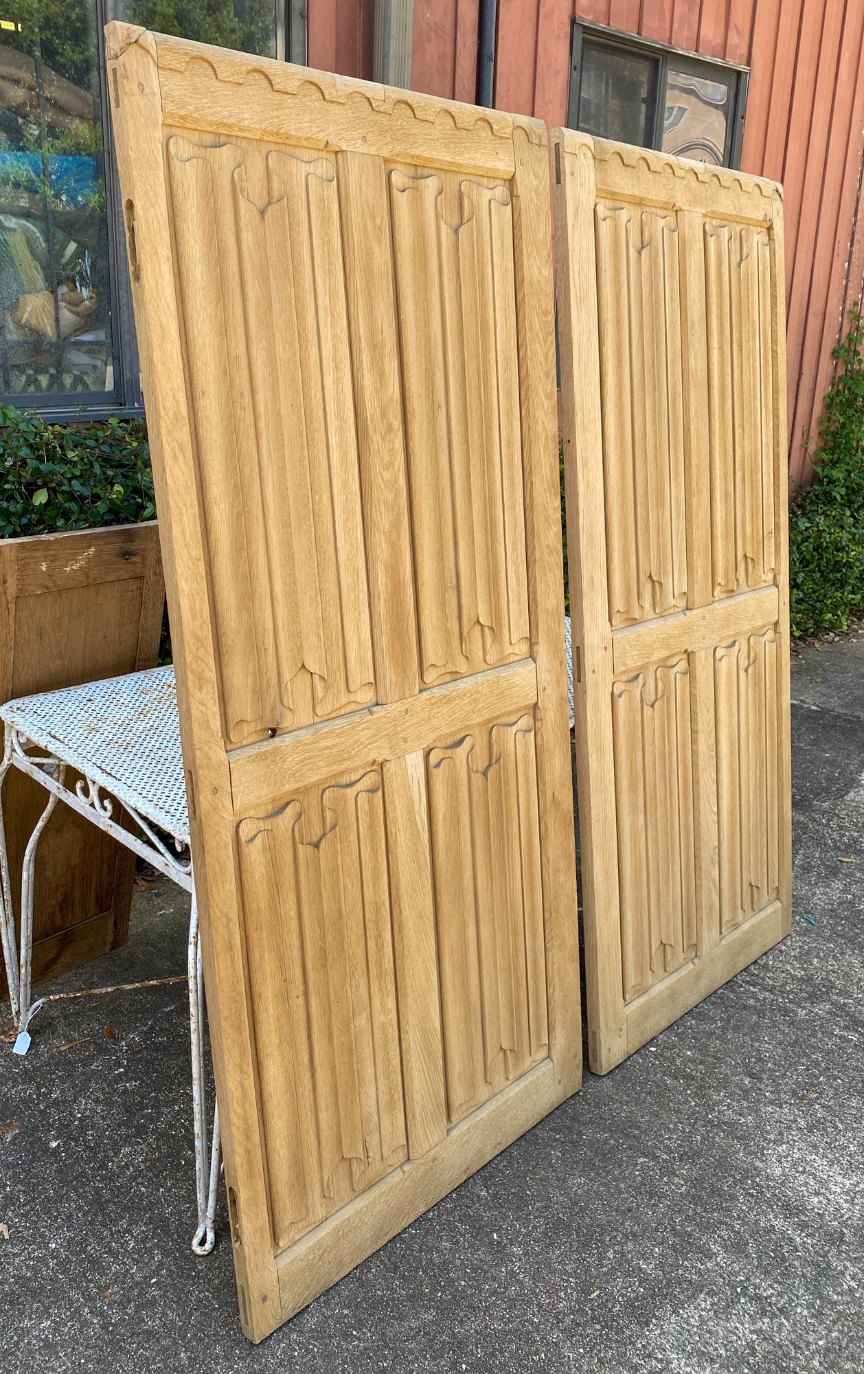 This is a set of four oak panels with beautifully delicate hand carved details that mimic folded fabric or paper. Sourced in England, two larger panels and two smaller ones make the set. These could be made into a room divider or installed as