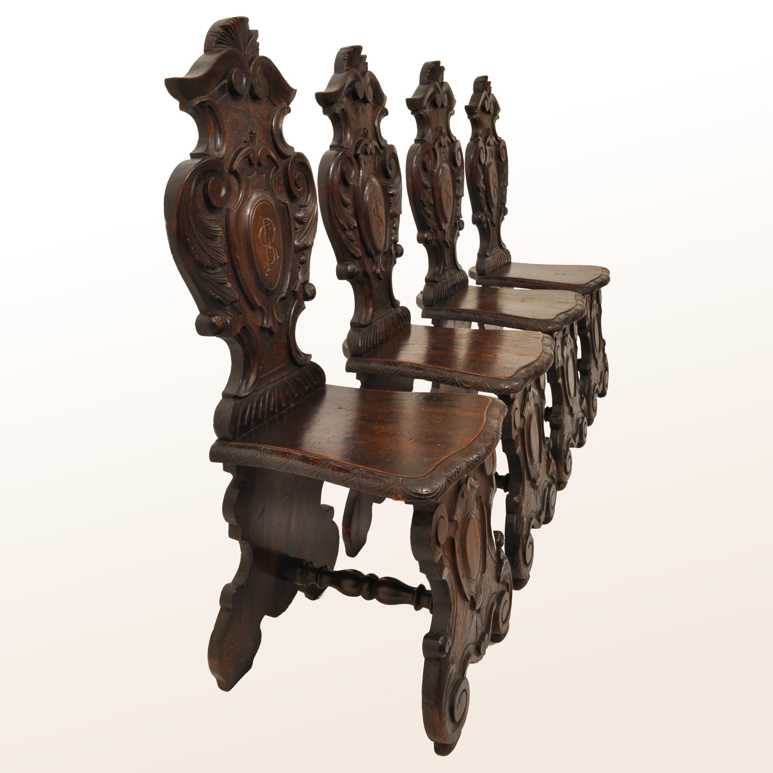 A good set of antique Italian carved Renaissance style, late 18th century Sgabello hall/side chairs, circa 1780.
The chairs having carved & scrolled shield shaped backs, the bases having a corresponding carved shield design, the seat bases are