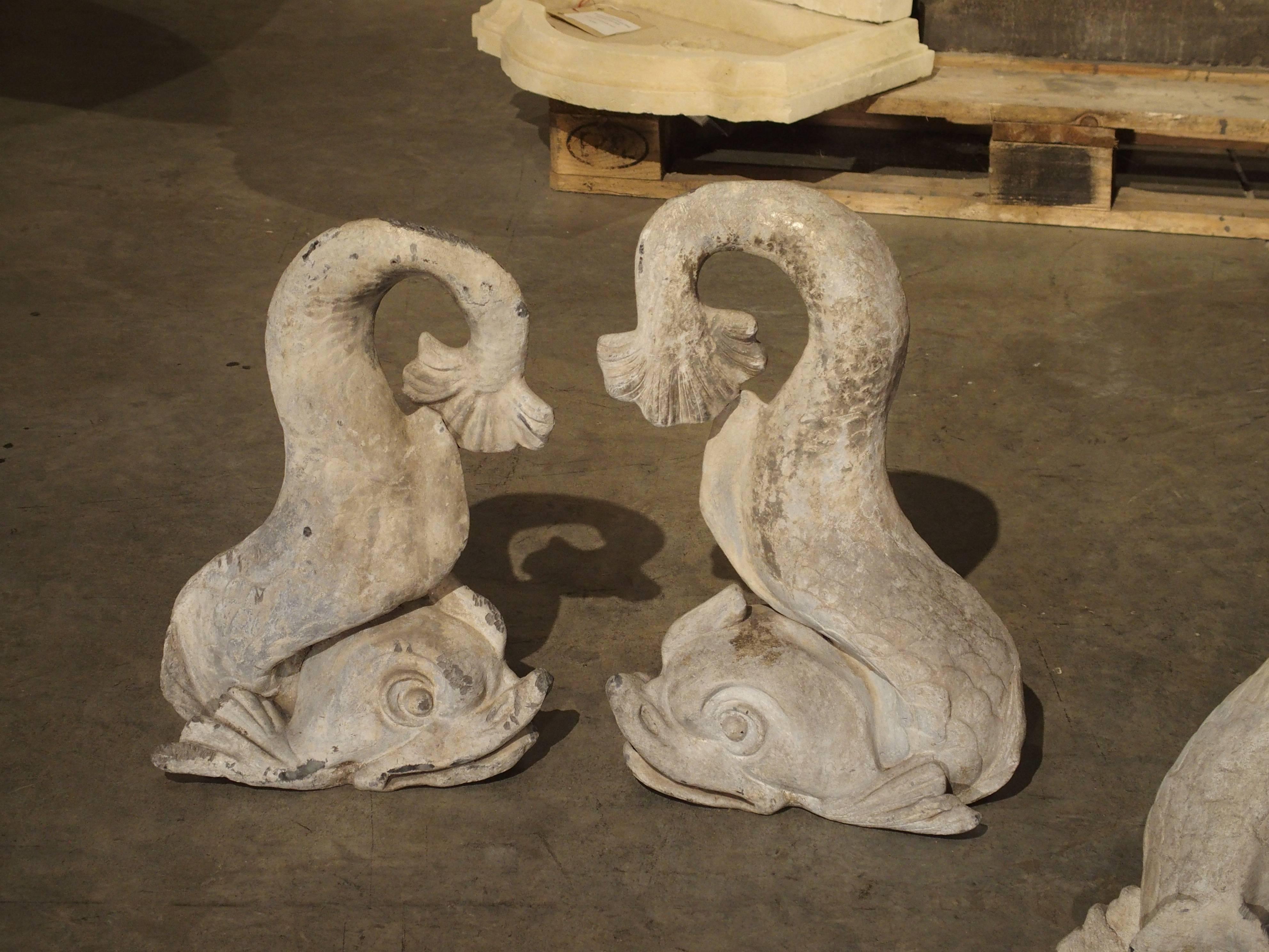 This wonderful group of four stylized dolphins from France were once part of a large French fountain. Of course, they can once again be incorporated into a fountain design. They would also serve as unique garden statuary or decorative pieces for the