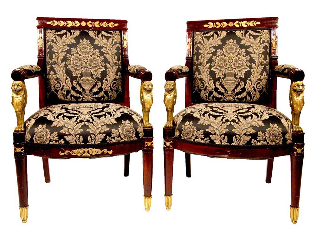 Amazing set of four antique Regency style armchairs, ornately decorated with bronze applique´, leaf foot caps and stunning bronze griffin arm details. The commanding chairs are made of solid cherry and upholstered in a wonderful French style floral