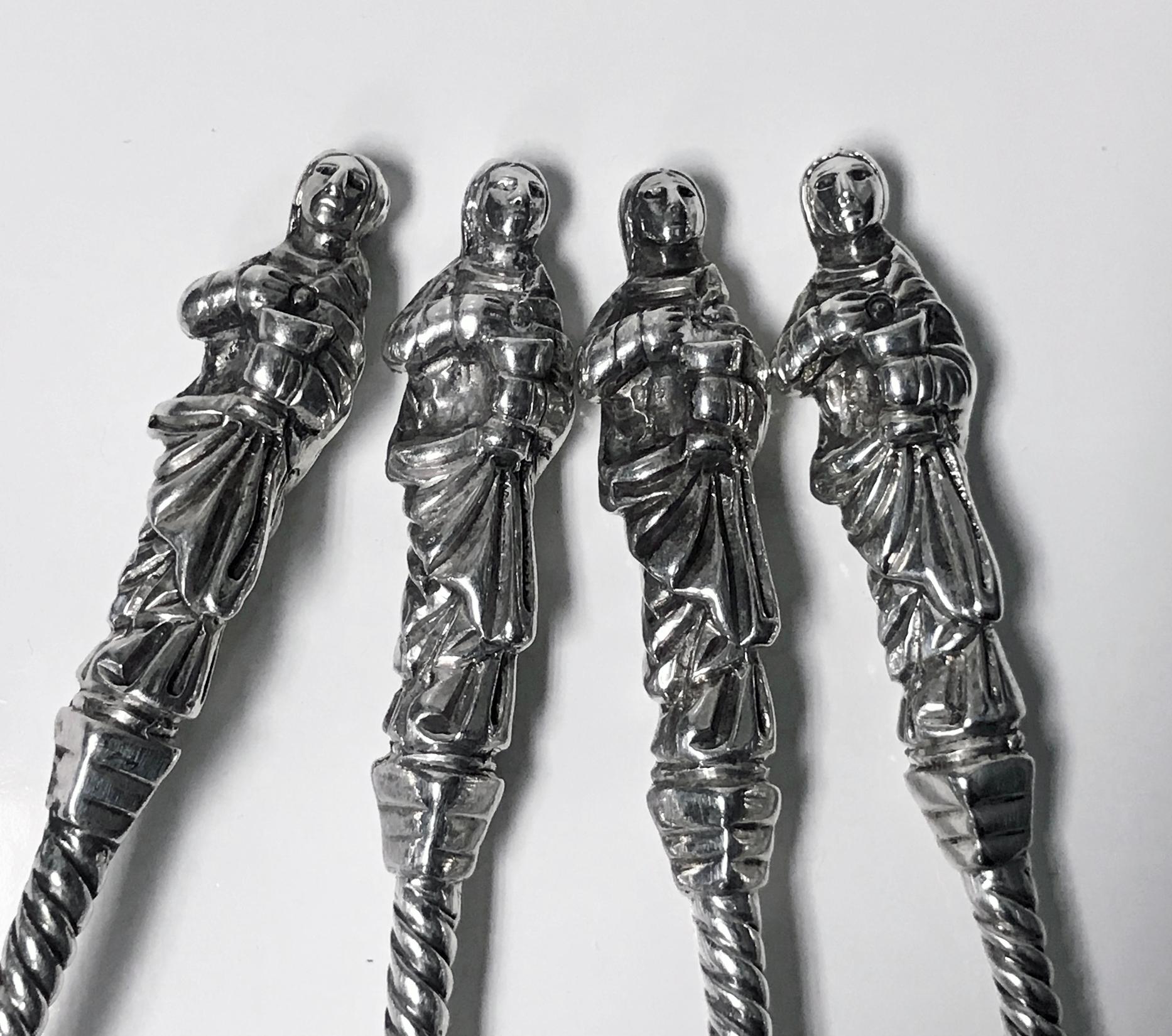 Set of four Victorian silver apostle spoons Edward Hutton London 1888. Each with fluted scallop shell bowls and part-twist stems, each with St. John finials. Lengths: 8.25 inches. Total weight: 277 grams.