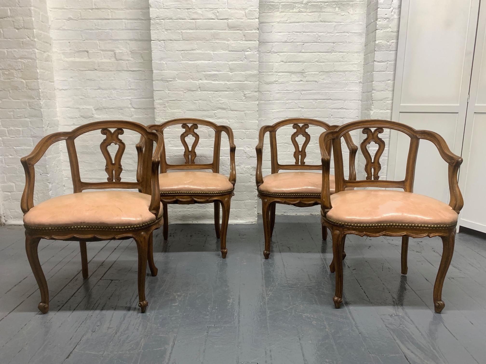 Set of four antique dining chairs. The chairs have a solid walnut frame with original leather seats. Chairs are low enough for breakfast chairs. Louis XV style.