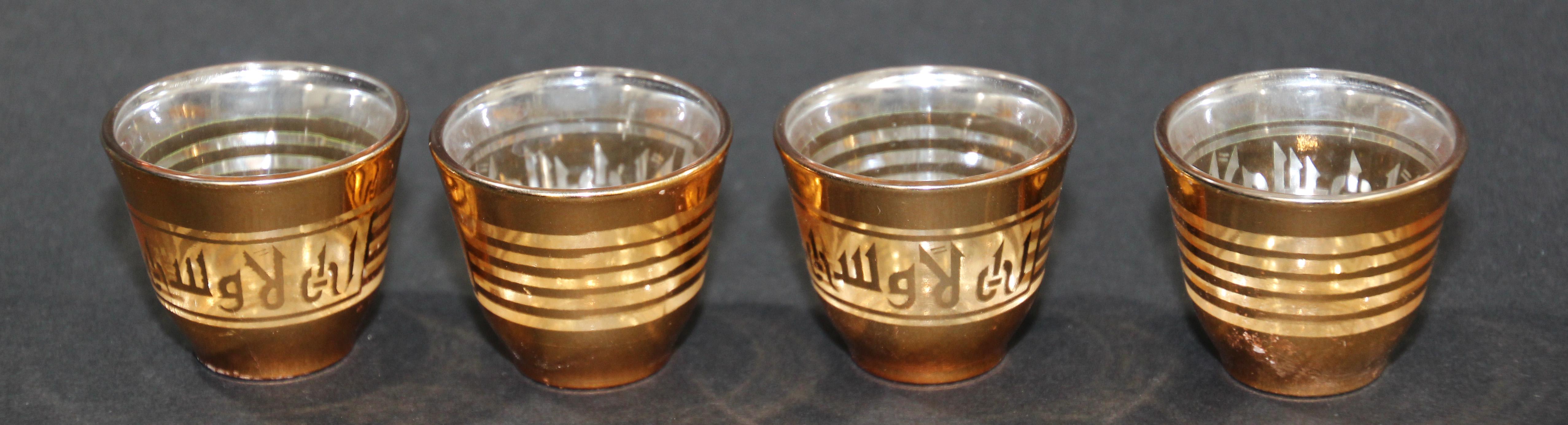 Set of four Arabic shot glasses with gold raised overlay design.
Use these elegant glasses for Moroccan, Middle Eastern, Persian tea, or any hot or cold shot liquor drink.
In fantastic condition, perfect for the holidays and gorgeous on display in
