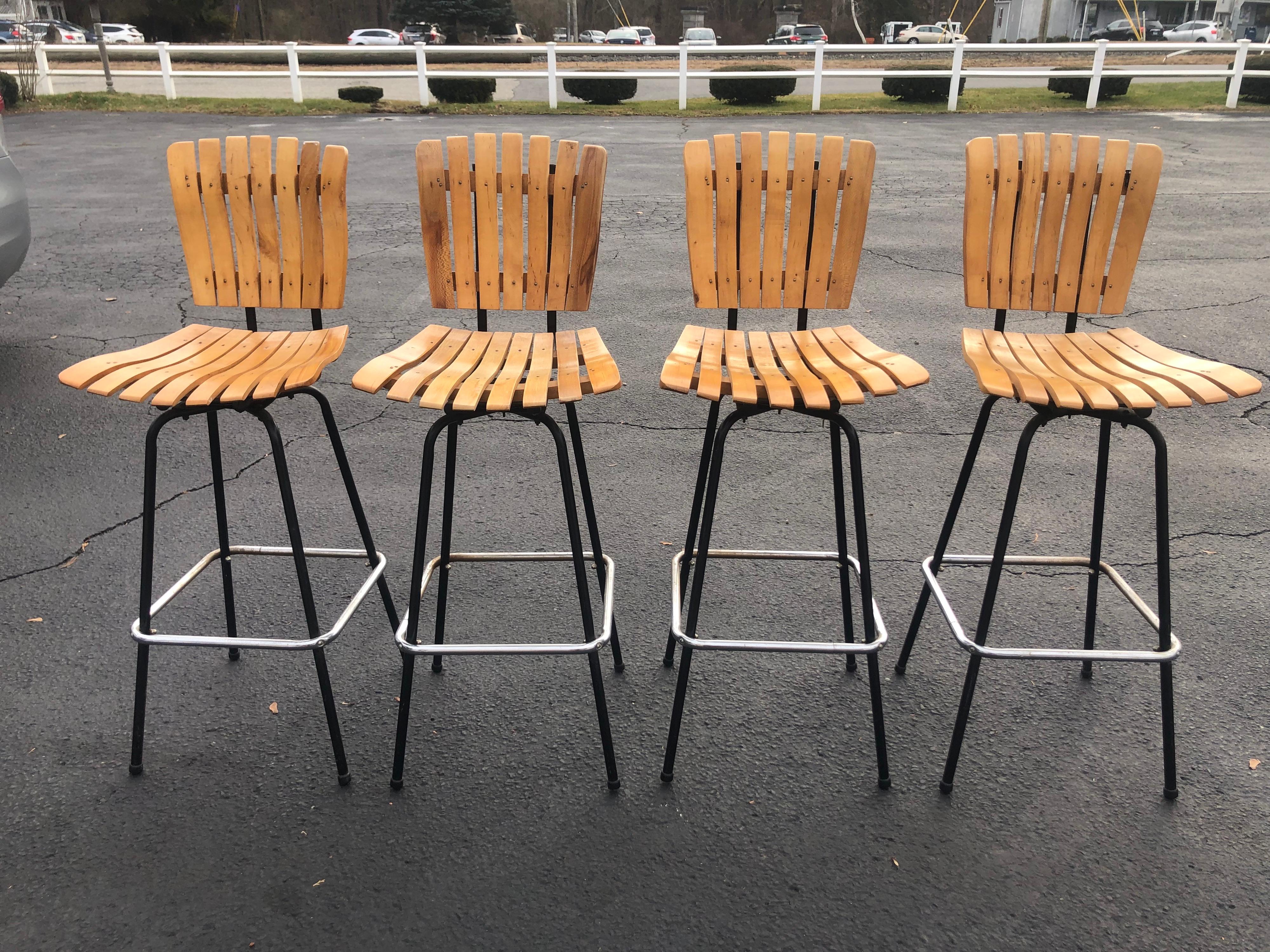 Set of Four Arhtur Umanoff swivel bar stools. Perfect for that Mid Century Man Cave Bar. 
Classic and timeless style. In very good condition.