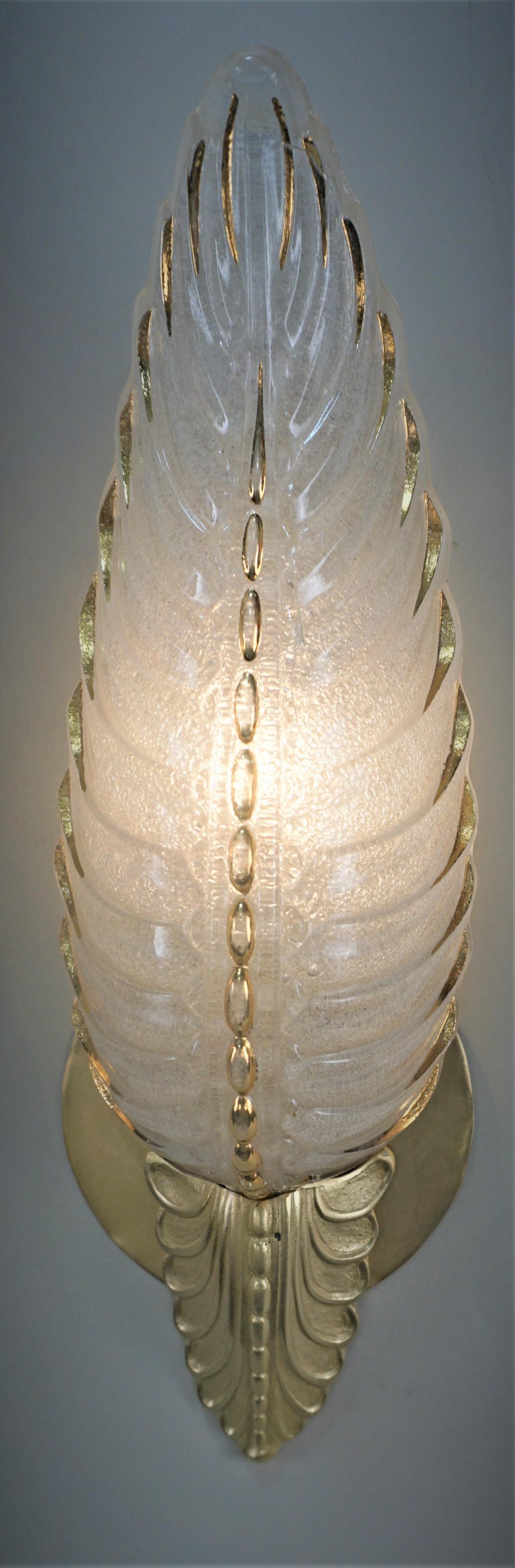 Two pair of art deco wall sconces in clear frost glass with touch of gold shades mounted in a bronze frame.
Total of four, Price for each pair.
 