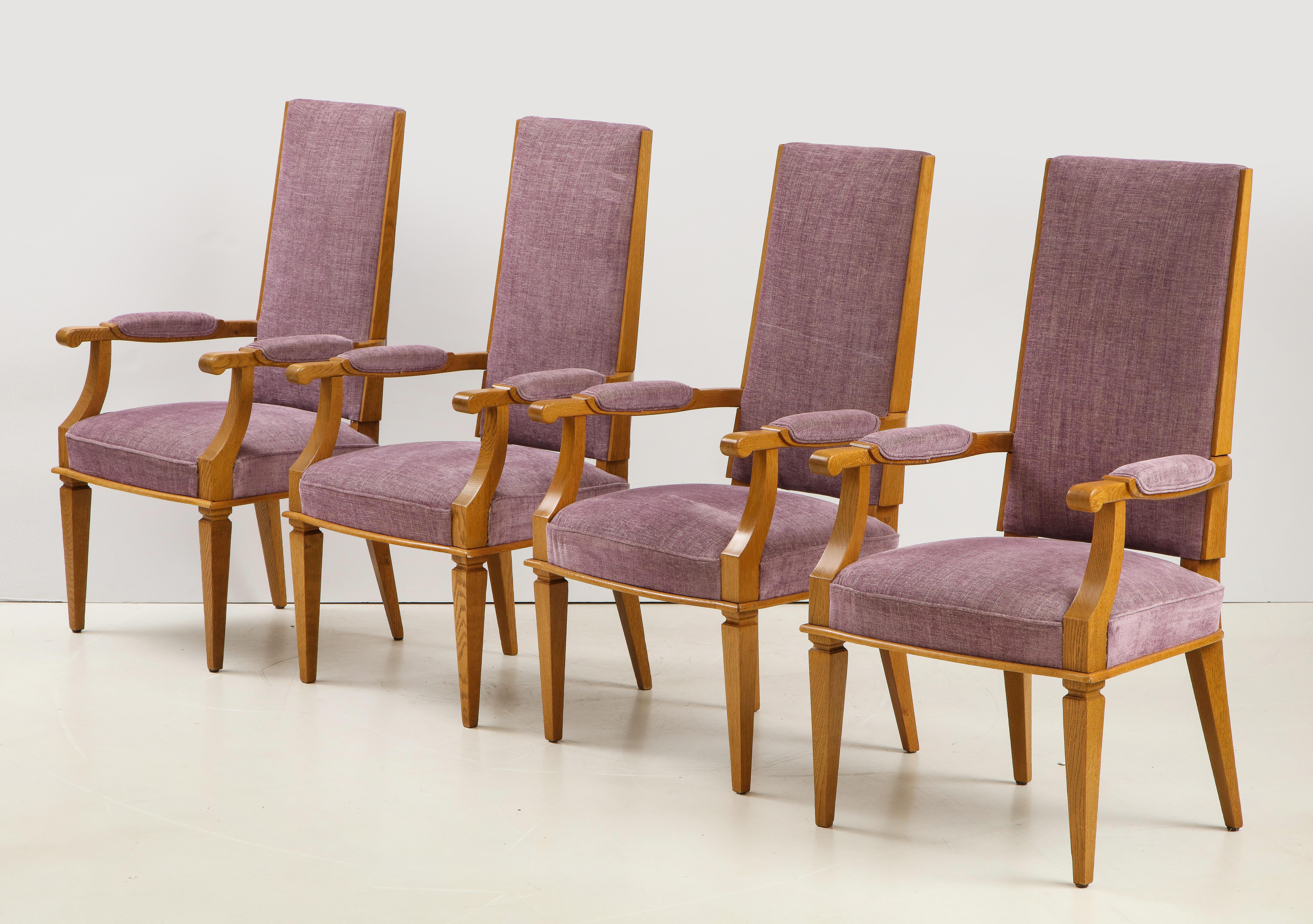 Set of four Art Deco oak armchairs by Jacques Adnet upholstered in fuschia color.