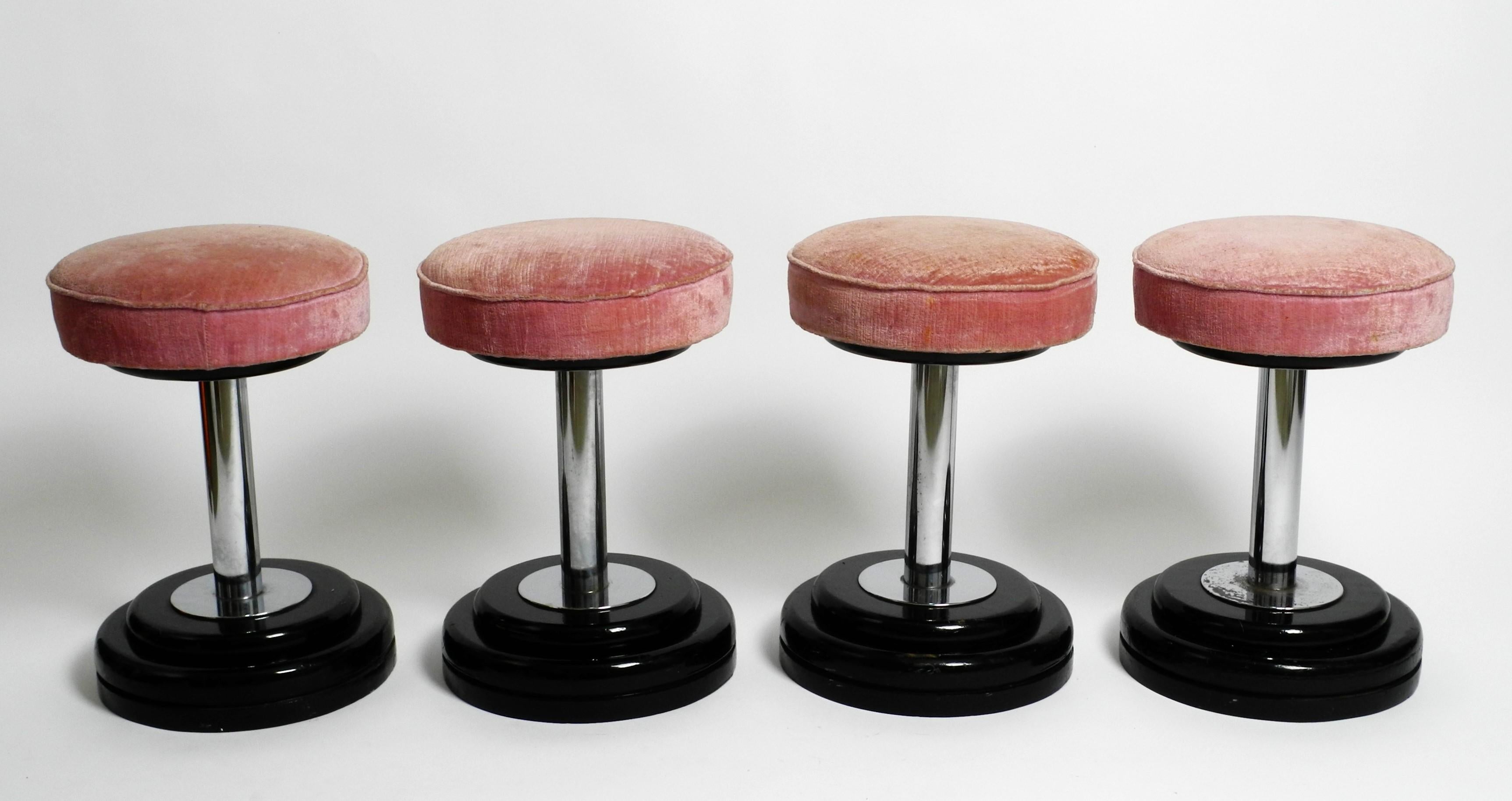 Stunning set of four Stools in Art Deco Style. Likely manufactured circa 1950.

Heavy wooden base. Chrome-plated steel tube. Padded seat with pink velvet cover.

They can be wonderfully combined with a coffee table or also be used with a dining