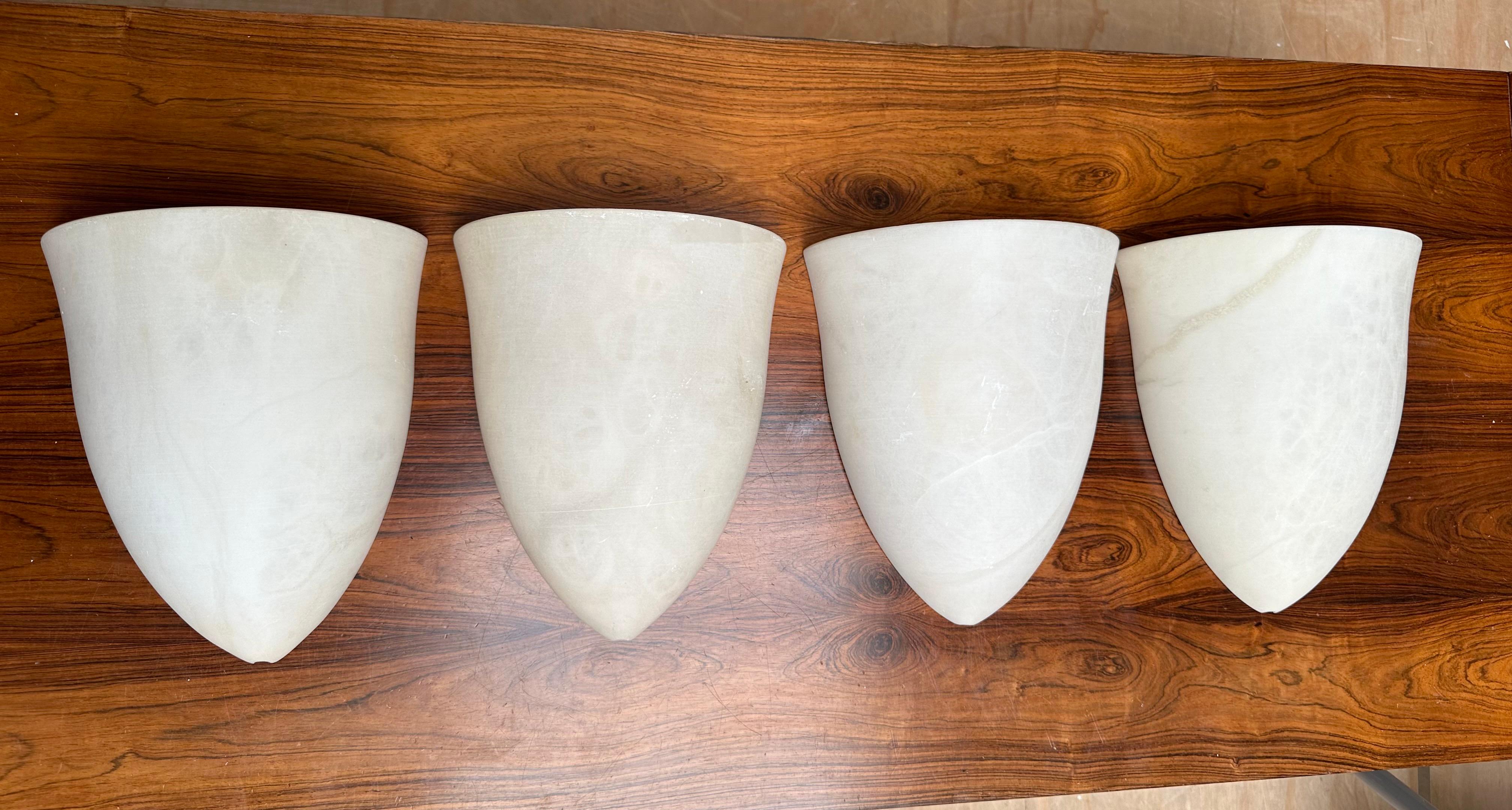 Handcrafted and very stylish set of midcentury made alabaster wall lights.

If you are looking for a great design and practical size set of four sconces to grace your living space then these natural mineral stone fixtures could be perfect. All