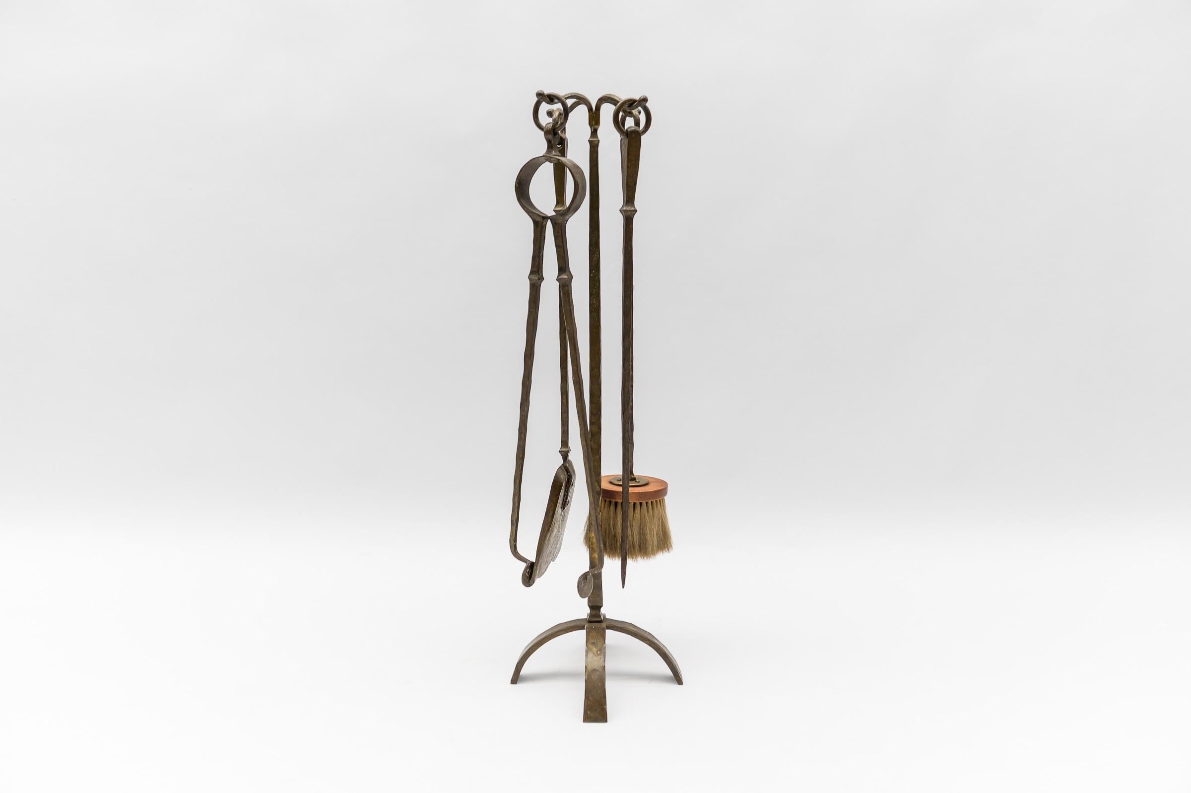 A set of four Arts & Crafts hand forged fire utensils on a hand forged iron stand.

 