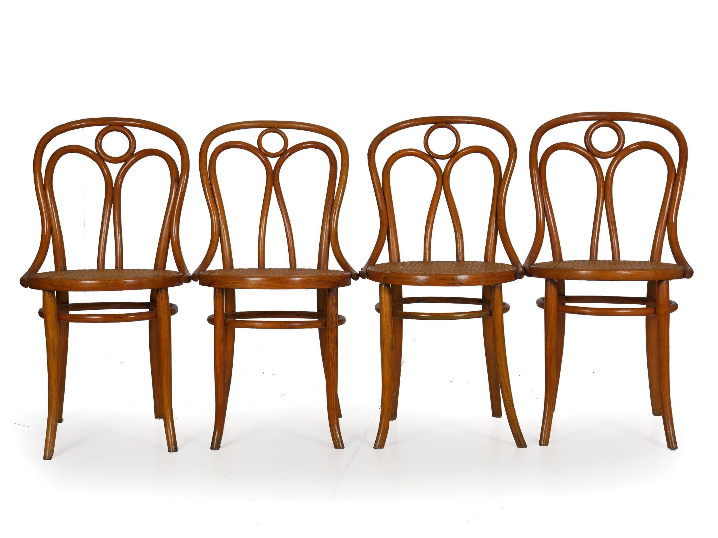 A fine set of late 19th century dining chairs designed by Josef Kohn and manufactured by Mundus, one still retaining the original label remnants, this is offered as no. 36 in his catalogue and is a quite rare form with the little circle in the crest