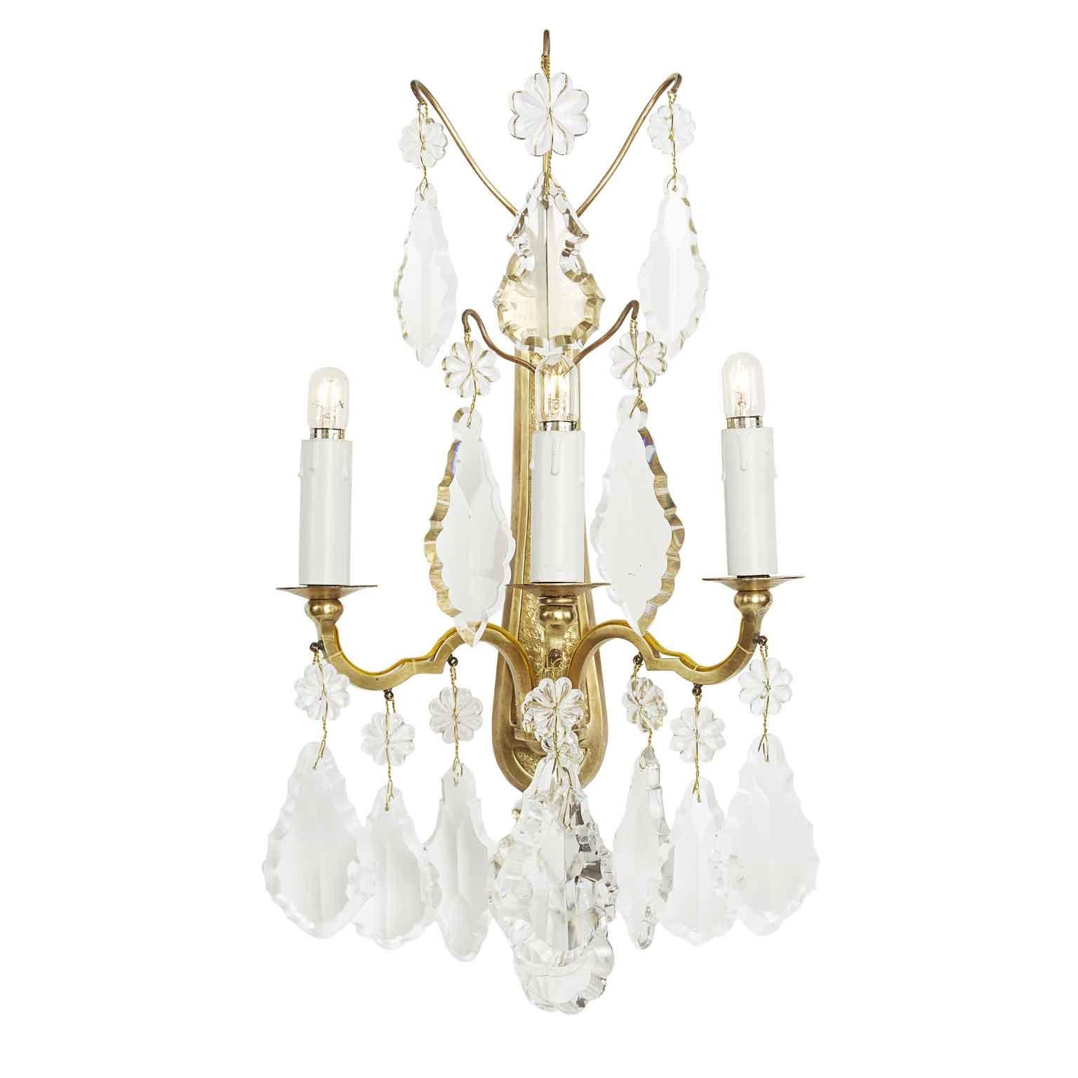 Four French Baccarat sconces dating back to early 1900, set of four three-light gilded bronze wall lamps , with fan shaped crystals. They are of French origin, as evidenced by the engraving of the legendary French Baccarat mark at the base of each