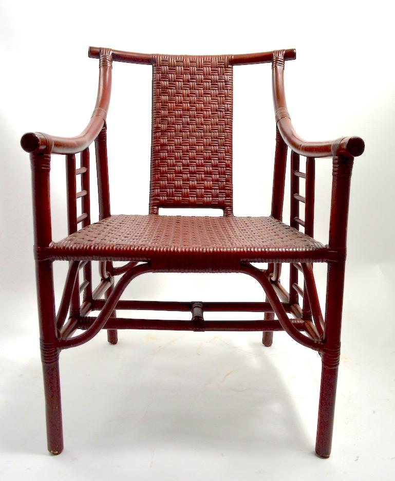 Set of four lounge, armchairs bamboo frames and woven cane seats and backs. All chairs are in good original condition, showing only light cosmetic wear, and paint loss in spots, normal and consistent with age. Design after Parzinger, Chinese