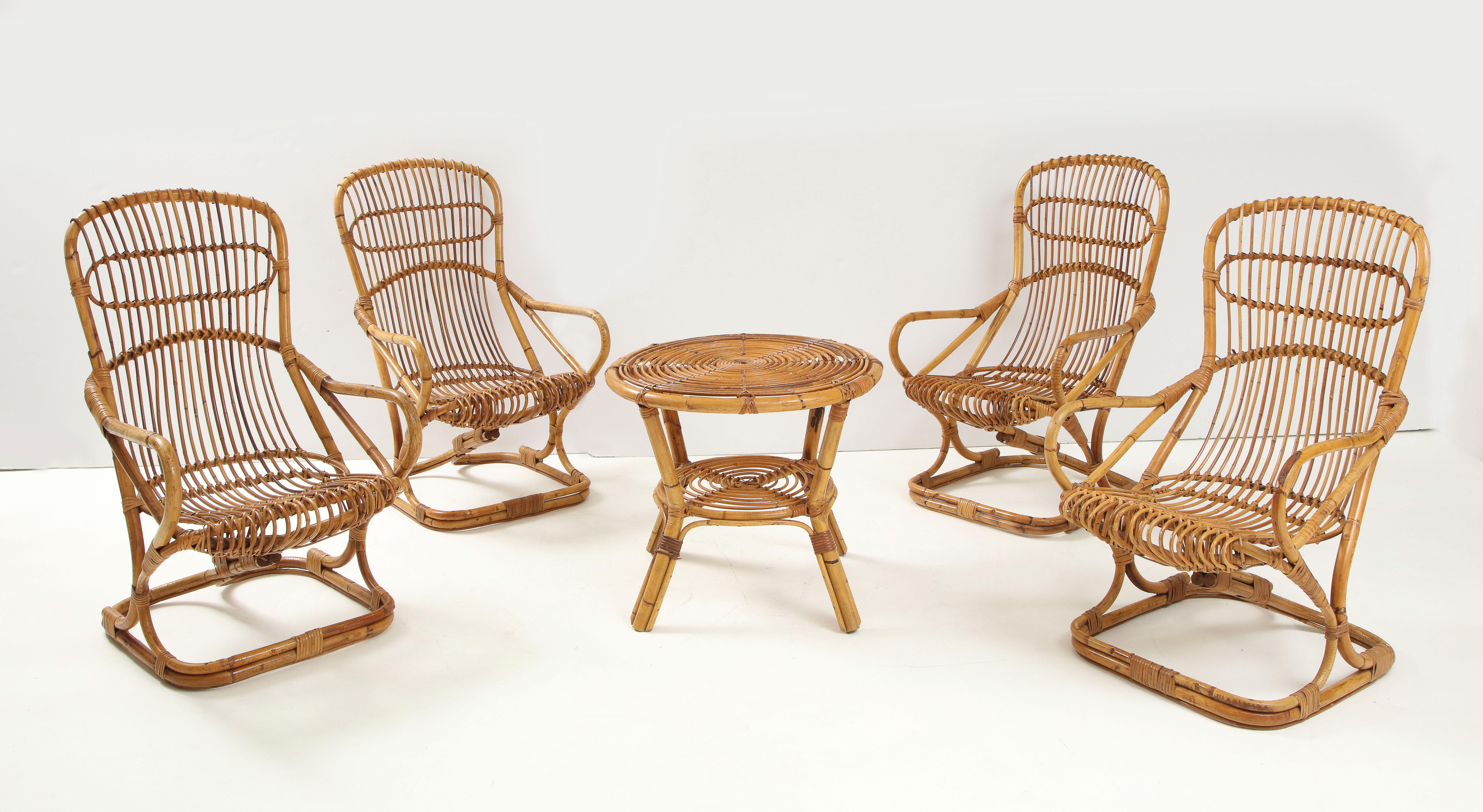 A set of four Italian bamboo armchairs by Bonacina, majestic in size and with great sculptural shape. They are rare and elegant, designed by Tito Agnoli for Bonacina in the 1960's. They are not rocking chairs, but do have a spring to the back, are