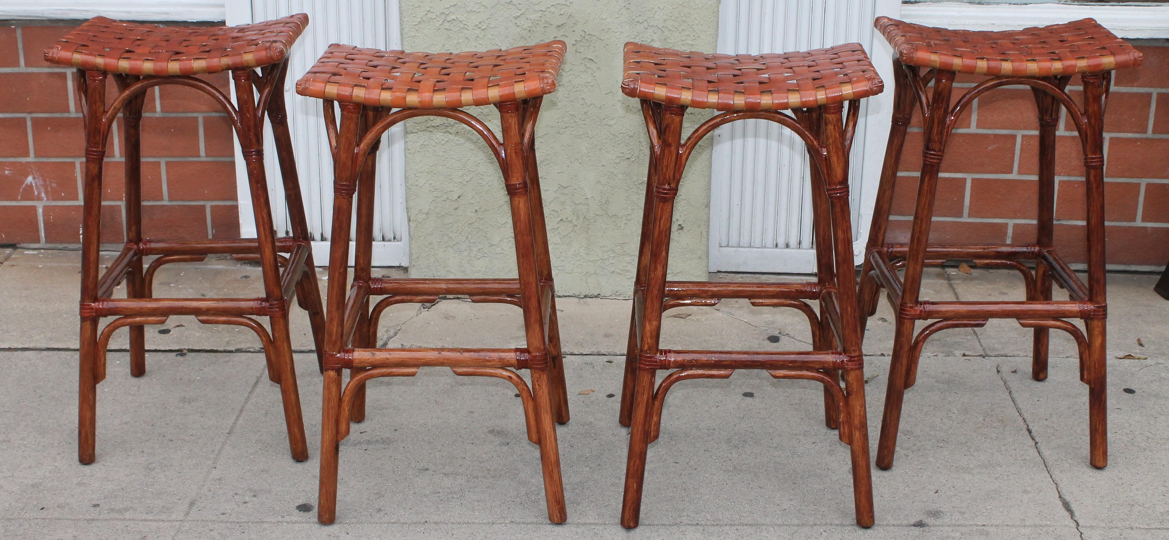 These Mid-Century Modern bamboo bar stools are in fine condition and have handwoven leather seats. They are counter or bar height. Super comfortable.