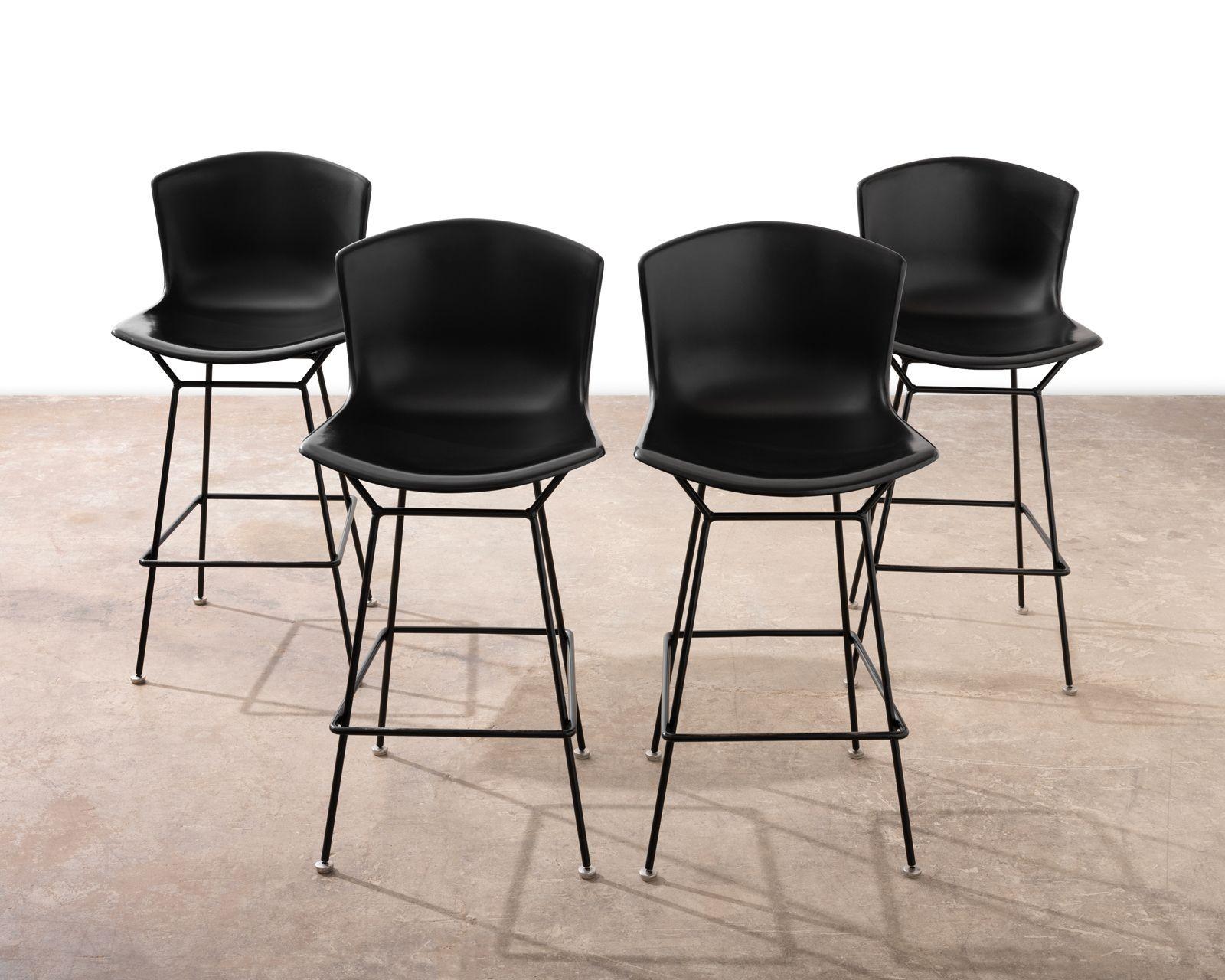 Acquired from retired architects estate. Set of four early production bar stools by Harry Bertoia, 1952 for Knoll. The bar stools are constructed of molded fiberglass and iron and are in very good condition.