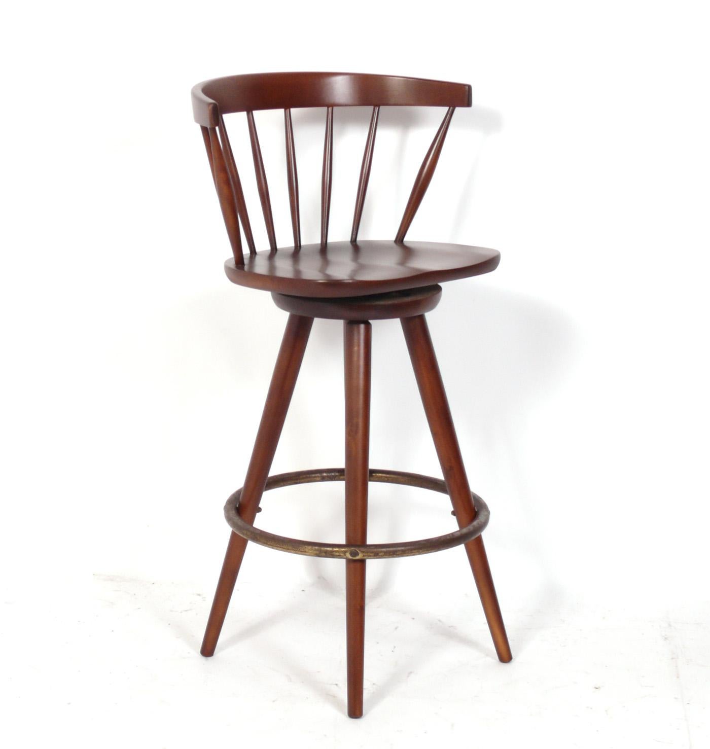 Set of Four Clean Lined Bar Stools, in the manner of George Nakashima, American, circa 1950s. These look very similar to the spindle back chairs that Nakashima designed for Knoll. They have been recently refinished in a medium brown walnut color and