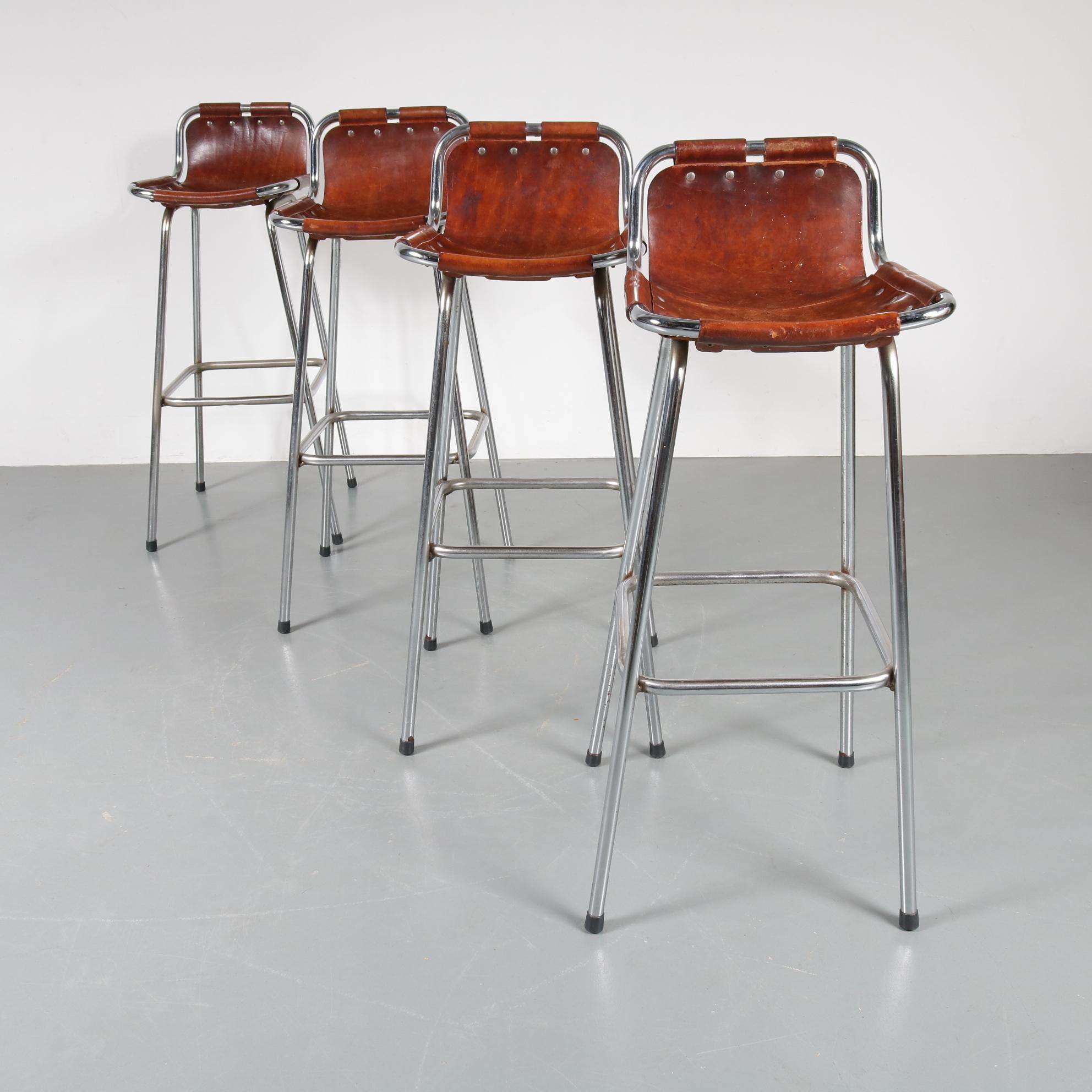 Stunning set of four bar stools selected by Charlotte Perriand for Les Arcs Ski Resort in France, manufactured circa 1960.

The bar stools have a beautiful chrome plated metal base and high quality leather seats with chrome plated buttons. This