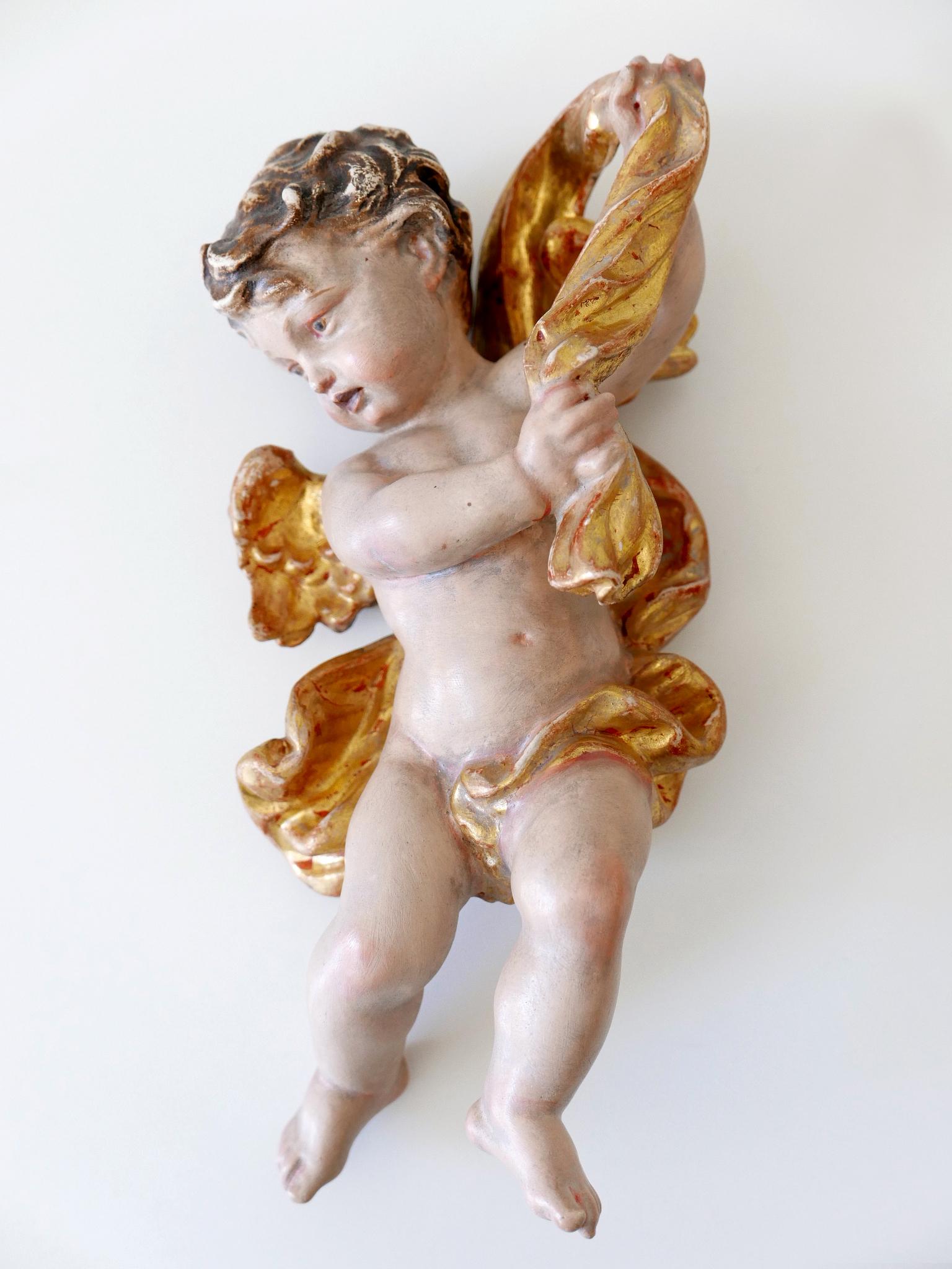 Set of four beautiful and highly decorative hand-carved painted wooden putti / cherubs.
Two of them are with label. L. Röger, Augsburg and Karl Storr, München. Made probably in 1960s. (Please see the images).

Dimensions of each putti / cherubs from