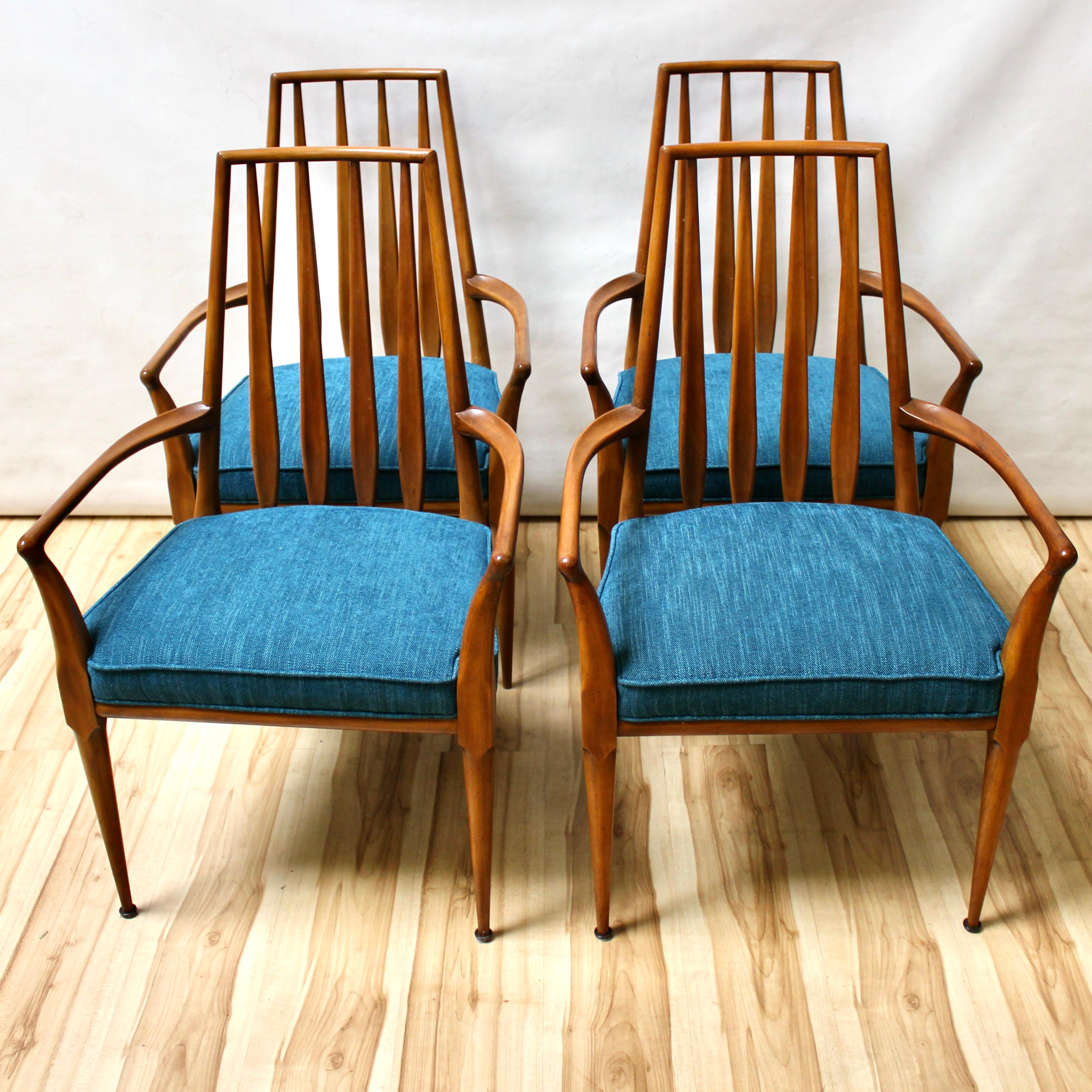 Set of four Mid-Century Modern dining chairs by Bert England. Similar in design to Scandinavian chairs of the period, they have been professionally reupholstered with new fabric and material. The chairs are all armchairs, and have blue upholstered
