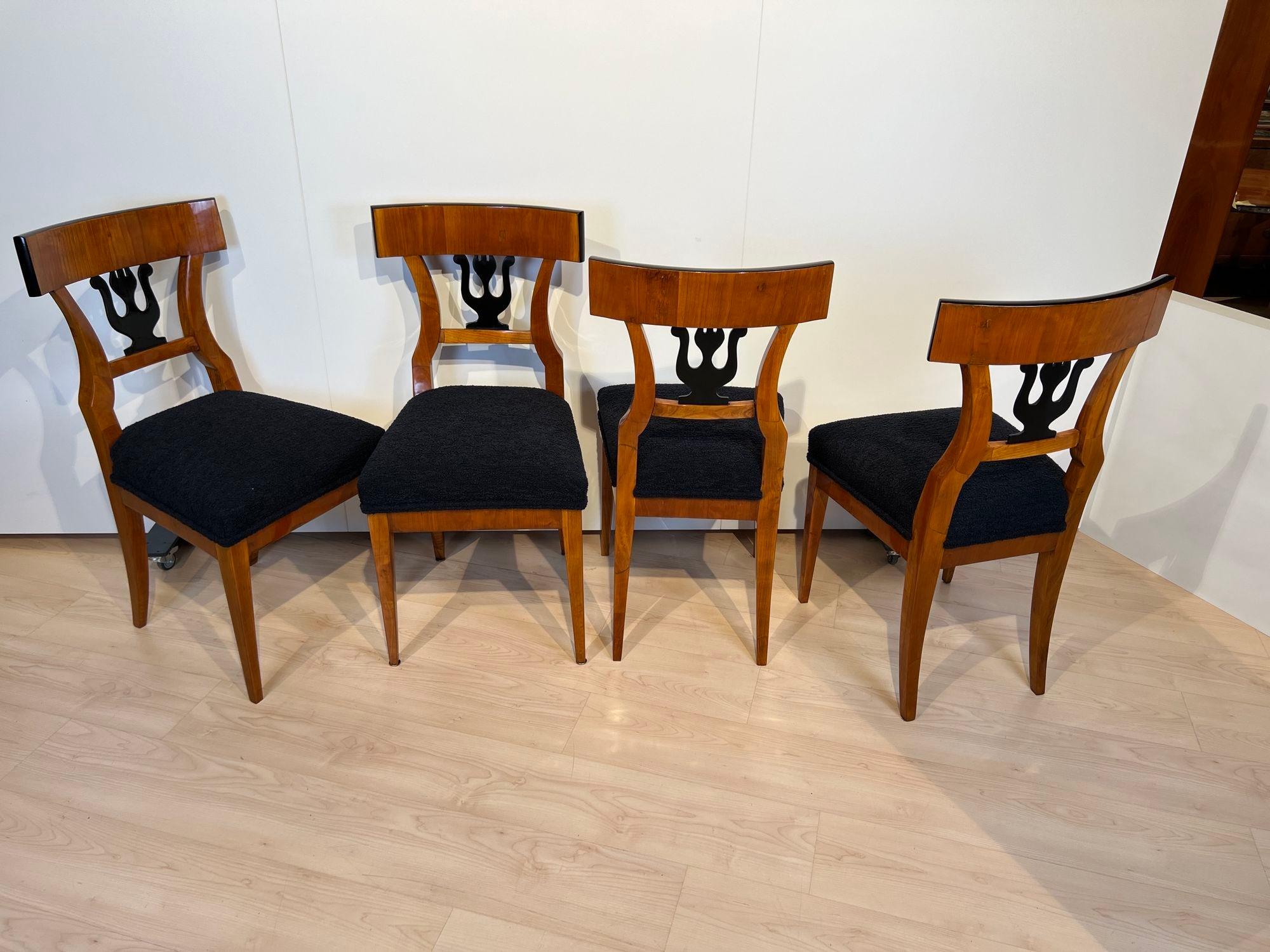Very elegant set of 4 Biedermeier chairs from southern Germany around 1830.
Cherry wood veneered and solid. Ebonized back decoration in the shape of a lyre, a very classicist motif.
Newly upholstered and covered in black fluffy fabric. Restored and