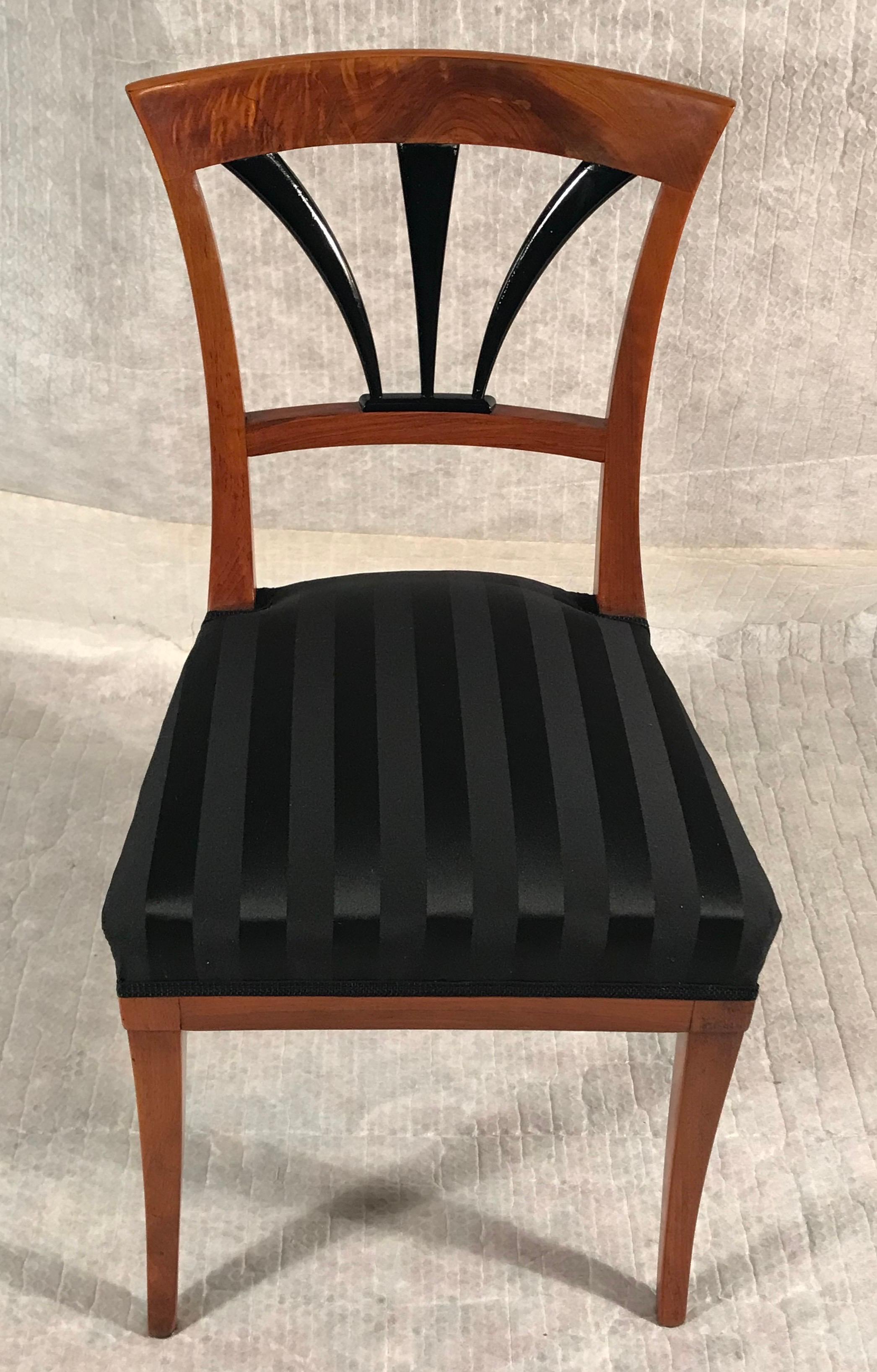 This set of four Biedermeier Chairs is a very pretty example of the elegance of Biedermeier chair design. The walnut veneered chairs have a a classic back decor with ebonized details. The come fully refinished with a newly added elegant black JAB