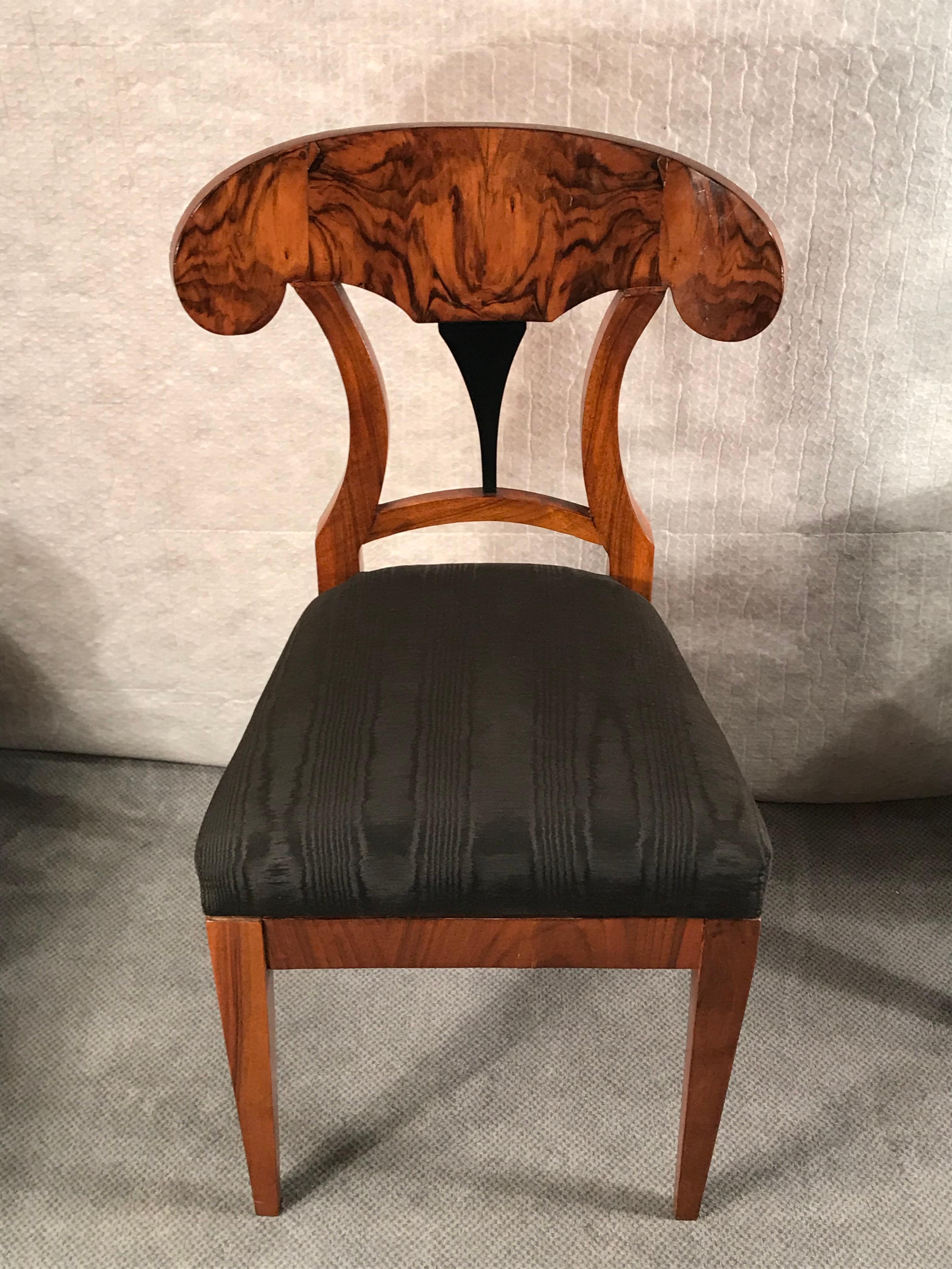 Set of four Biedermeier chairs, South Germany 1820.

These original beautiful Biedermeier chairs have a pretty shovel back with an ebonized detail. They are in very good condition. The chairs ship from Germany and include shipping costs and duty