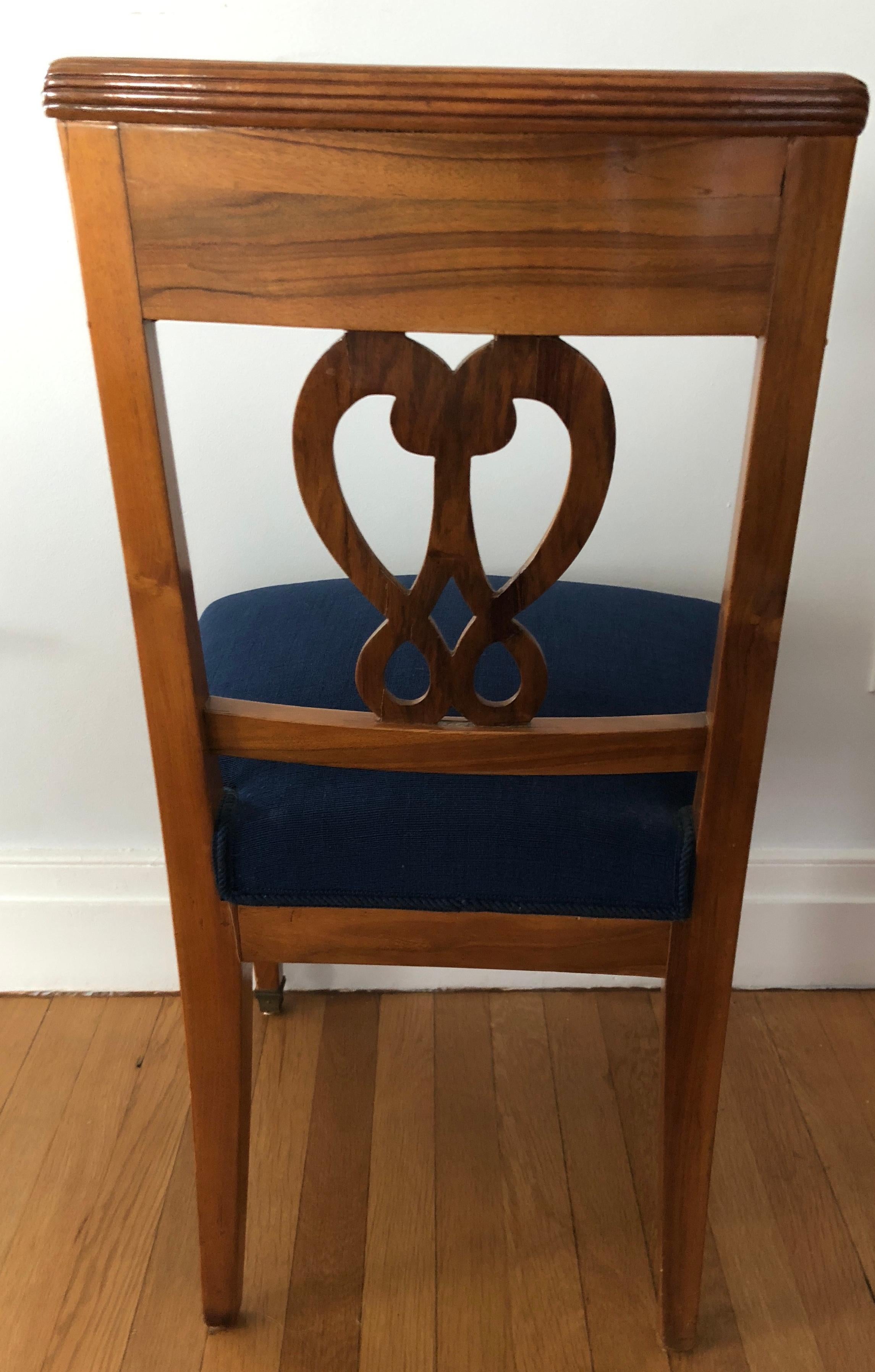 A set of four Biedermeier chairs, Switzerland, 1820-1830, walnut veneer. Beautiful back with a “Pretzel”decor and a beautiful carving on the top of the chair. The chairs are in good original condition.