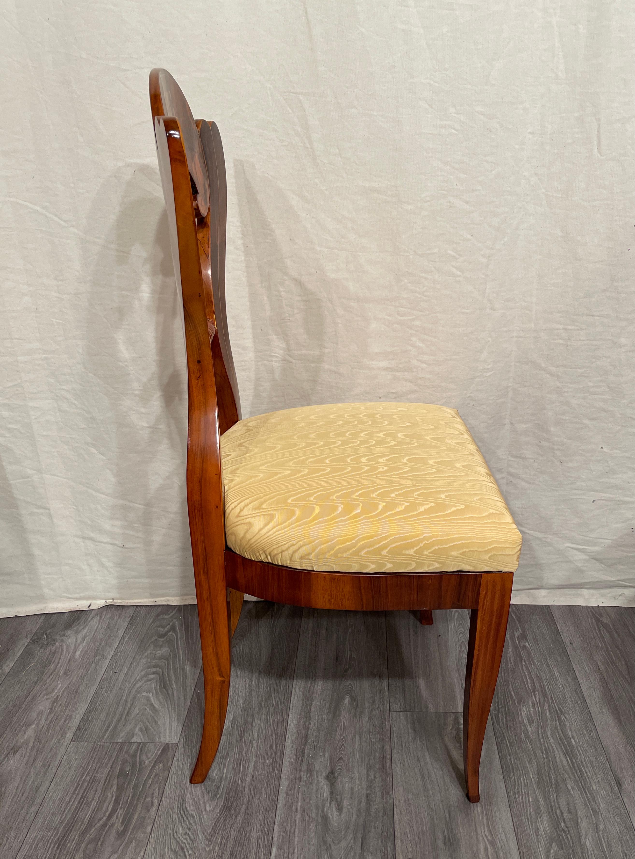 A set of four Biedermeier chairs, Vienna 1820. 
This exquisite set of four chairs shows definitely an influence of the Danhauser workshop in Vienna. The chairs have a beautifully shaped backrest and are embellishes with a gorgeous walnut veneer.