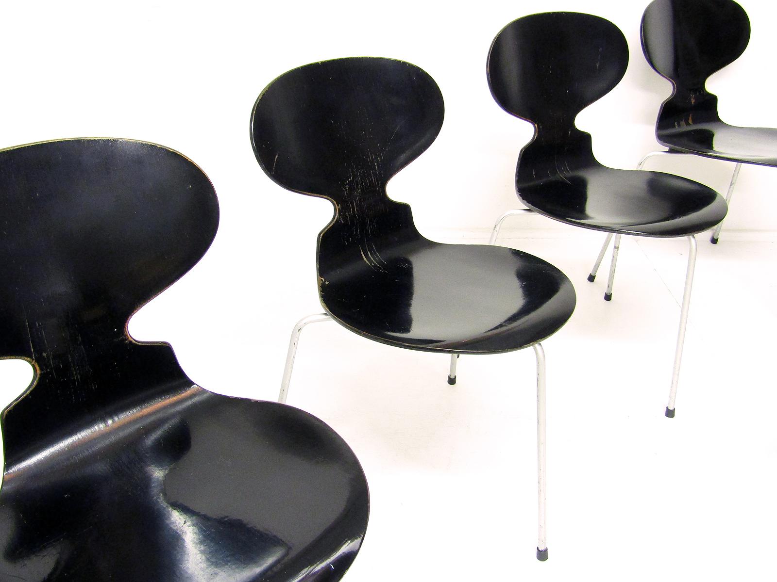 A beautiful set of four black 1950s Ant chairs by Arne Jacobsen for Fritz Hansen.

This very early edition has the original rubber disc spacers underneath, similar to Eames construction. The same detail can be seen on Ant chairs at MOMA and the