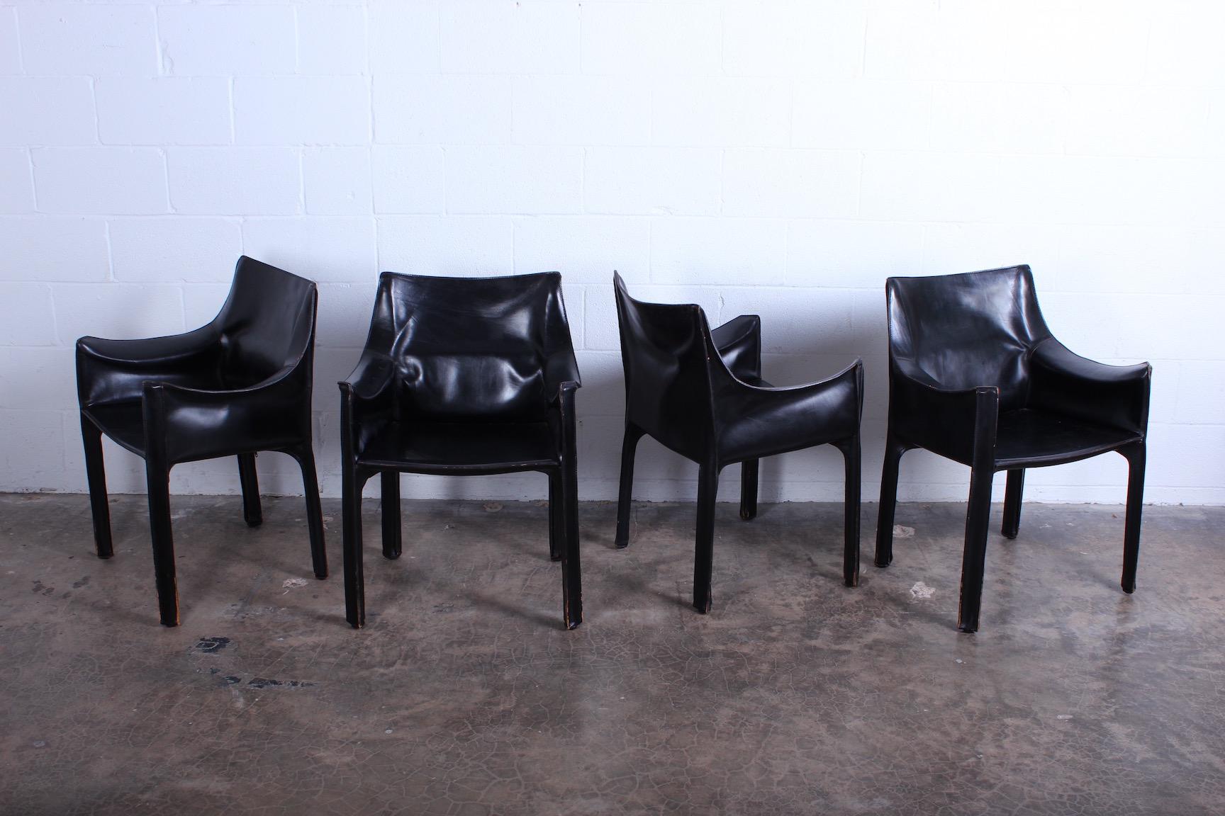 A vintage set of black leather cab armchairs with nice patina. Designed by Mario Bellini for Cassina.