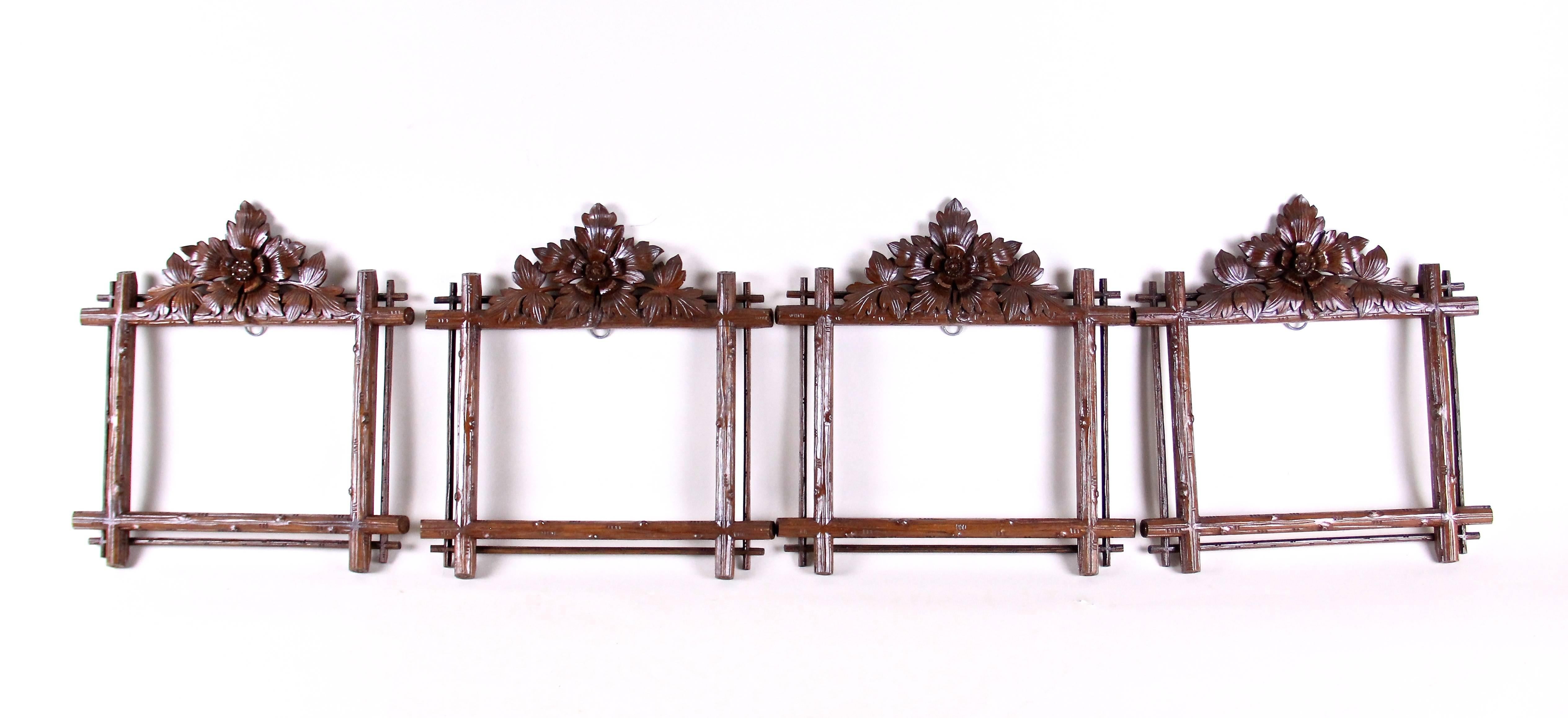 Spectacular Black Forest picture frame set of four from the late 19th century in Austria. Impressing with a fantastic looking hand-carved design, these unique frames shows delicate tree-branch style carved bars surrounded by four narrow bars. The