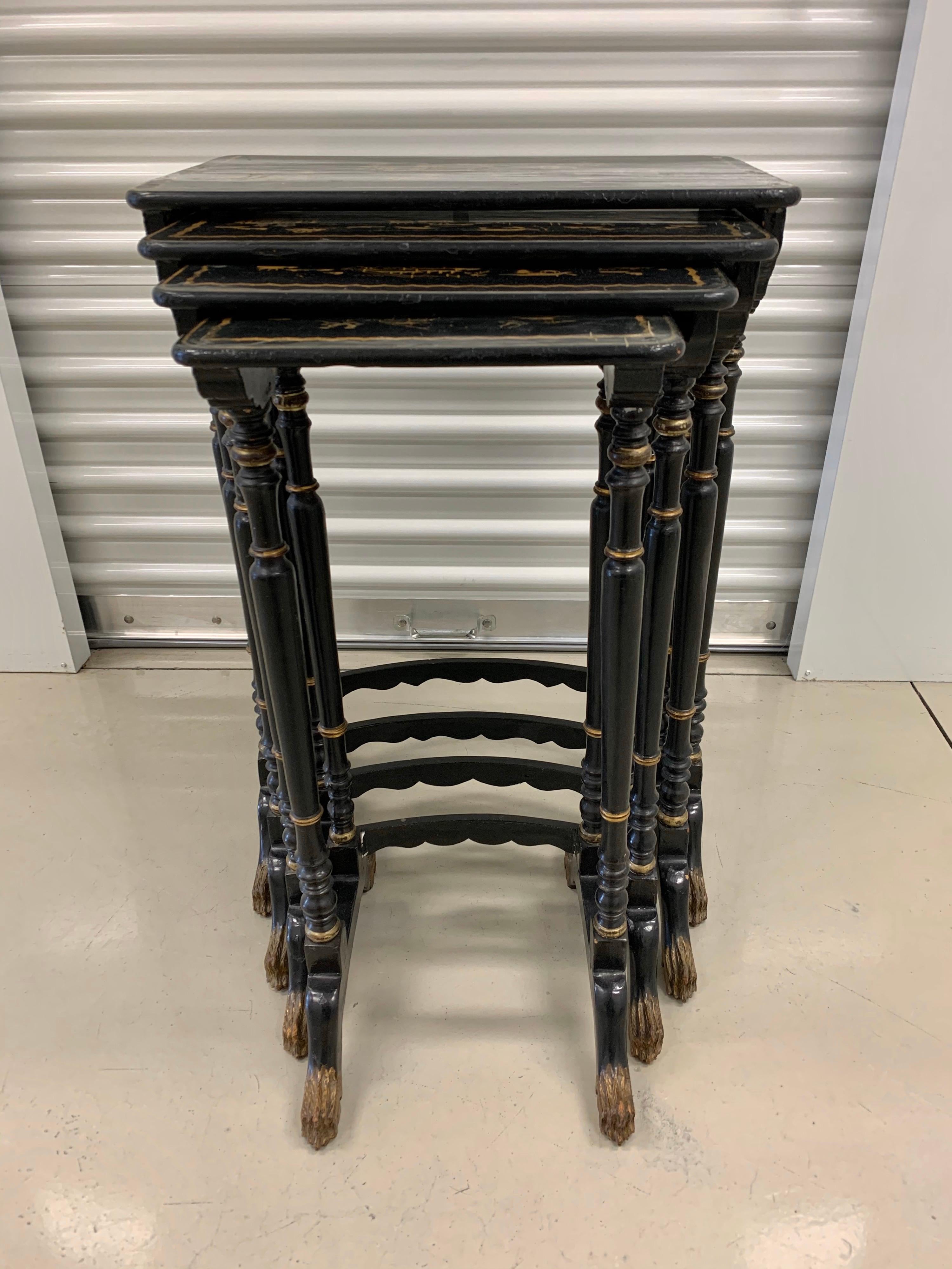 Mid-19th century set of four black lacquer Japanned stack tables. Features include
chinoiserie gold painted accents with much detail and stunning, detailed legs.
Dimensions for tallest table are below and others are as follows in descending