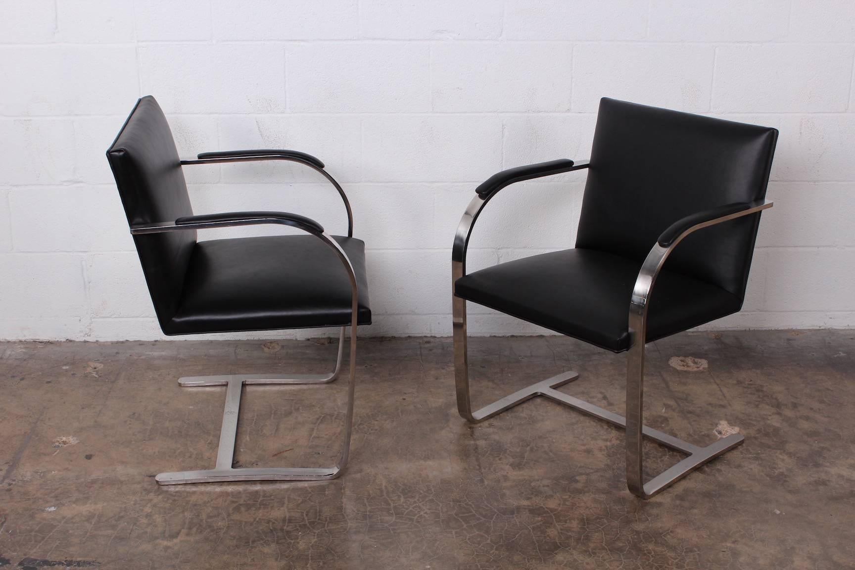 A set of four polished stainless steel and black leather Brno chairs designed by Ludwig Mies van der Rohe for Knoll.