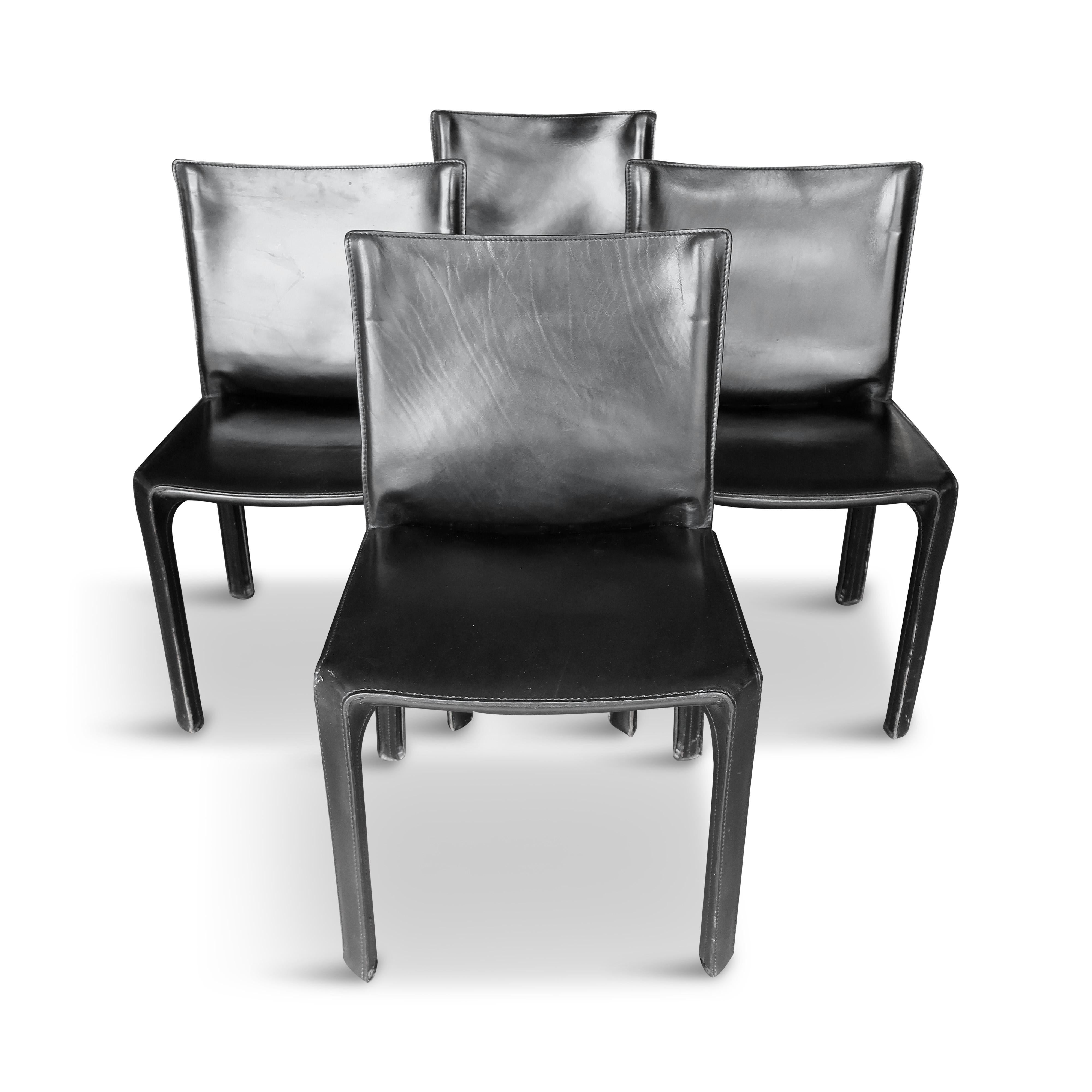 A set of four of 20th century Italian design icons in black saddle leather, the CAB 412 chair by Mario Bellini for Cassina. When first produced in 1977, the CAB was the first chair to feature a free-standing leather structure, inspired by how human